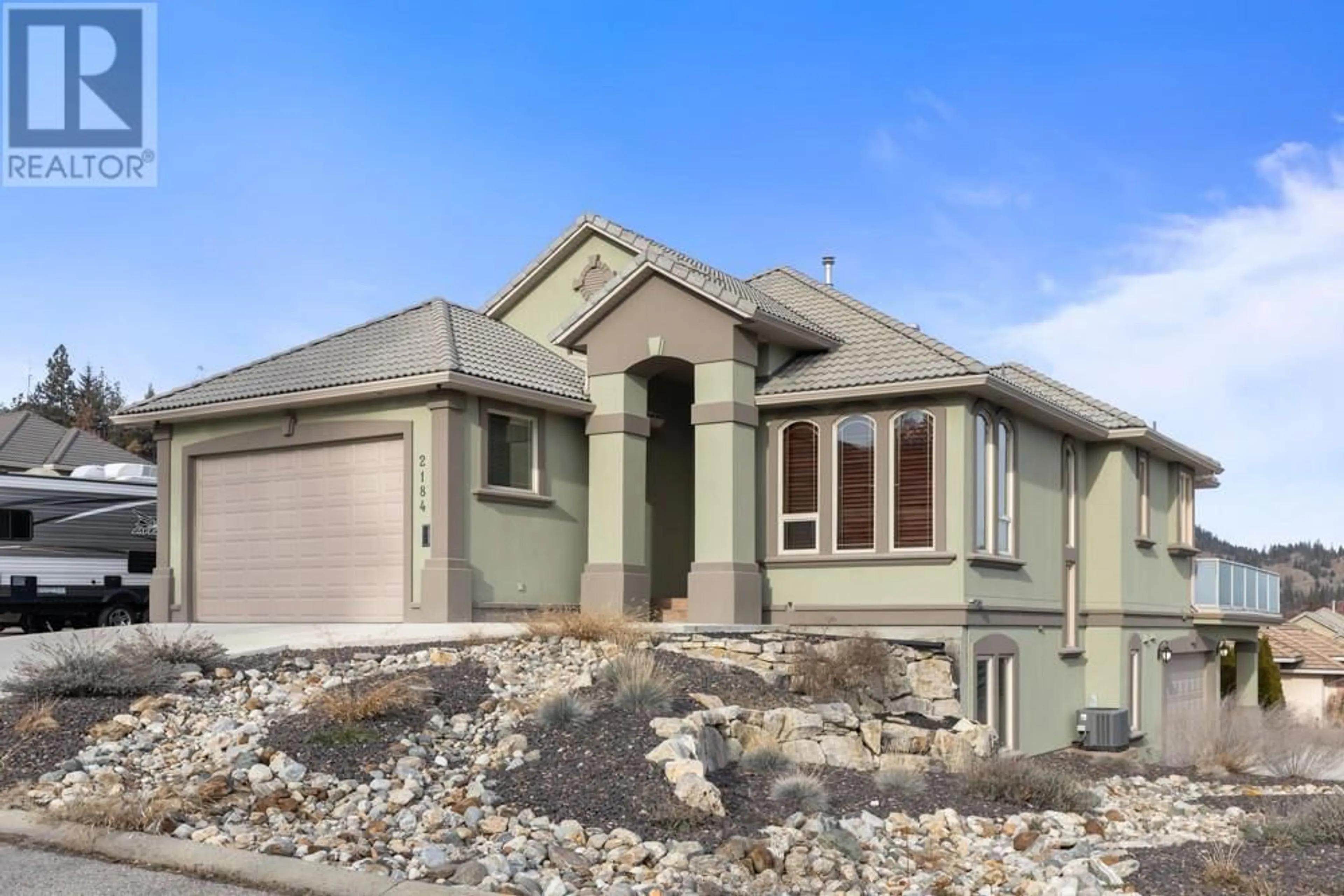 Home with vinyl exterior material, street for 2184 Capistrano Crescent, Kelowna British Columbia V1V2A3