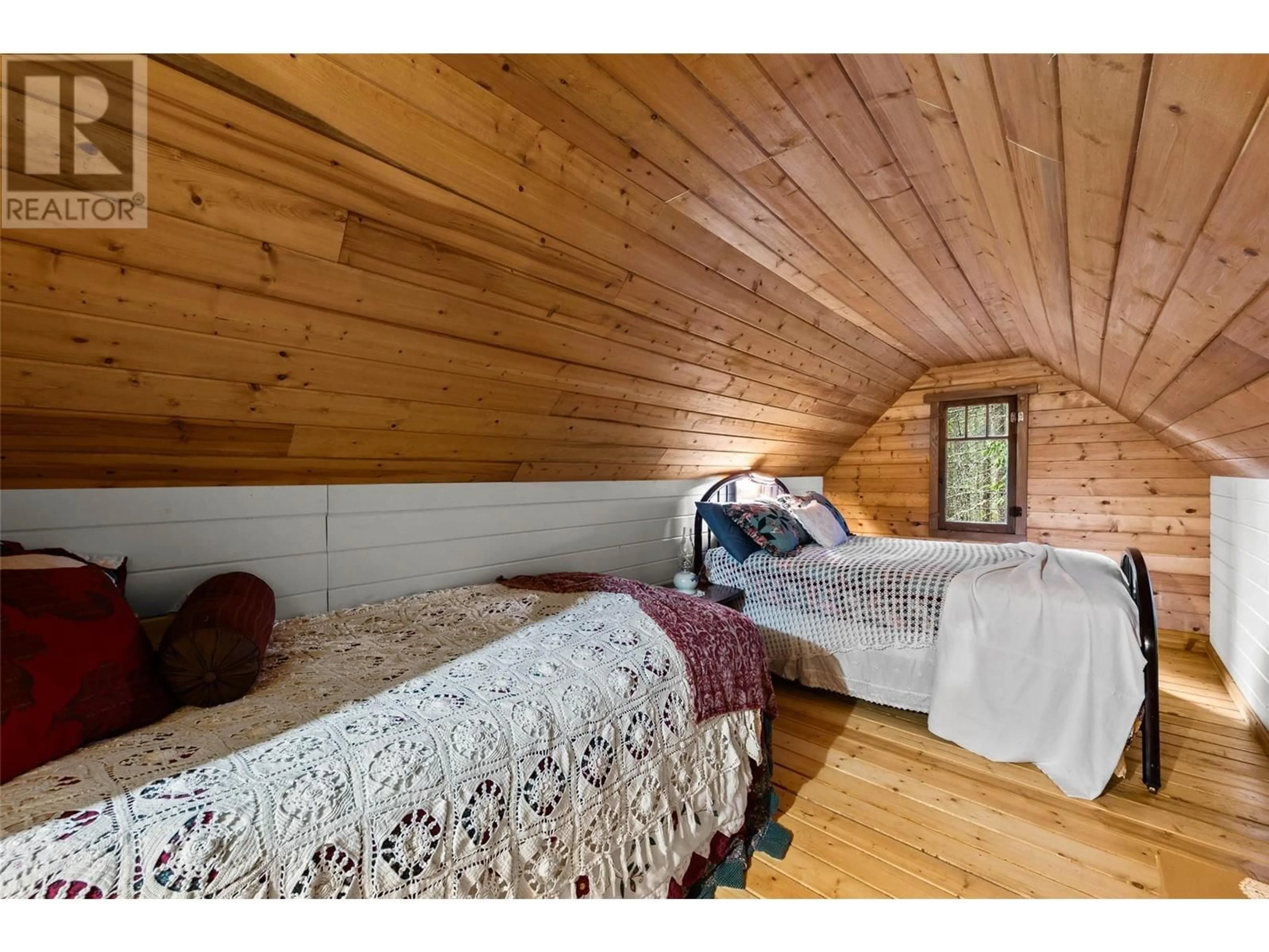 Bedroom with bed, wood/laminate floor for 6057 Line 17 Road, Magna Bay British Columbia V0E1M7