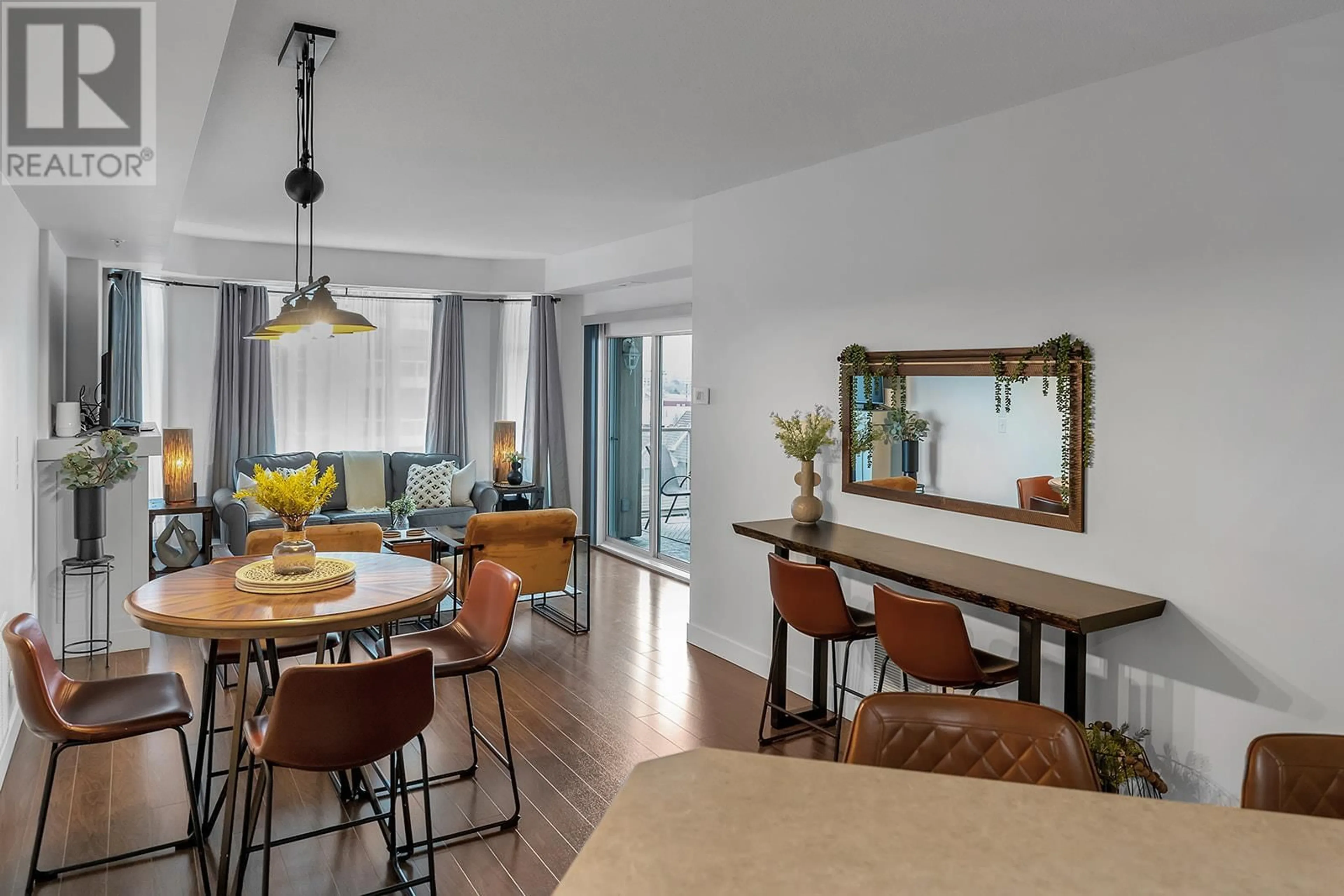 Dining room, wood/laminate floor for 702 - 1128 SUNSET DRIVE, Kelowna British Columbia V1Y9W7