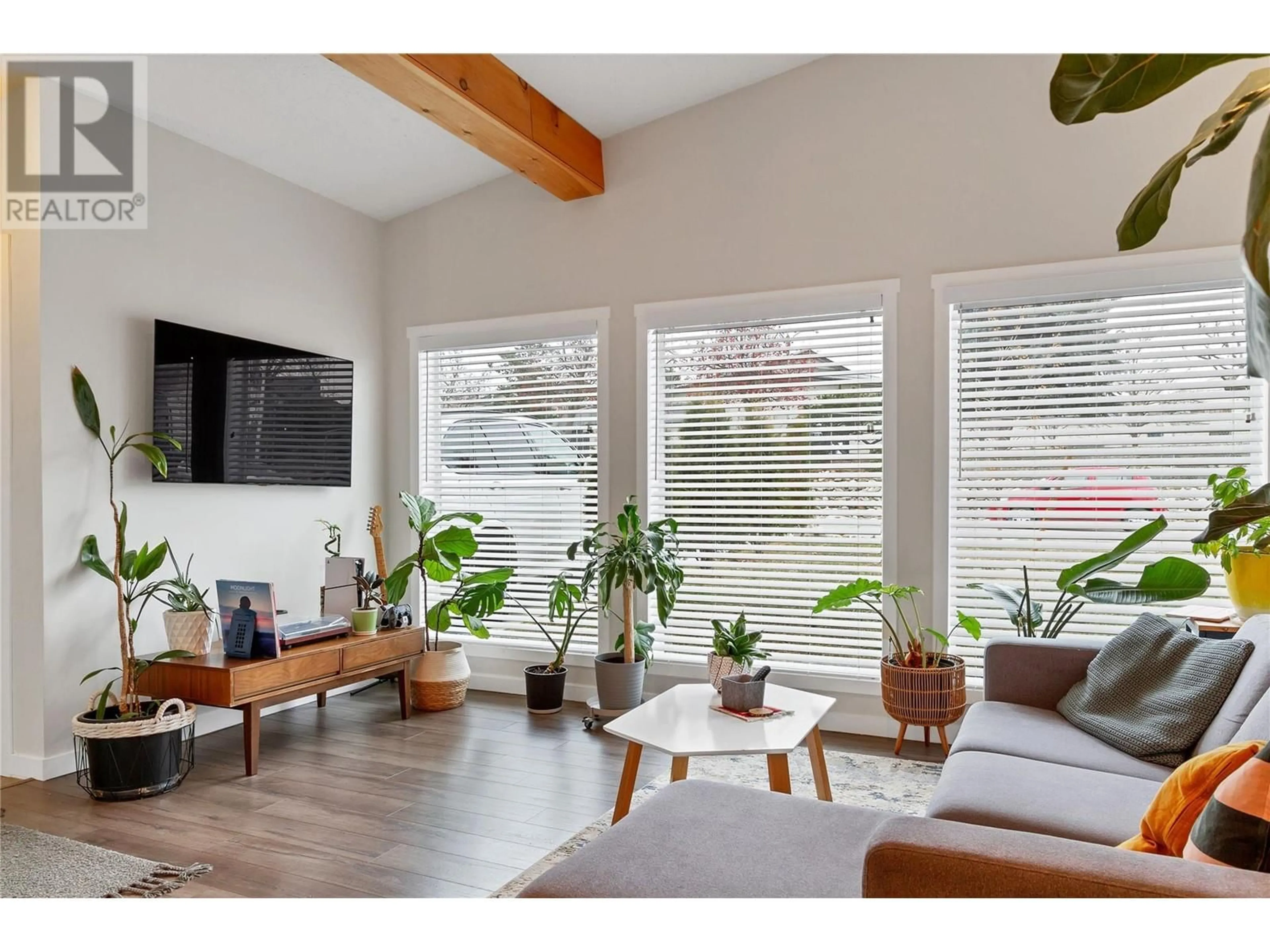 Living room with furniture, wood/laminate floor for 3605 Commonage Crescent, Vernon British Columbia V1T8M4