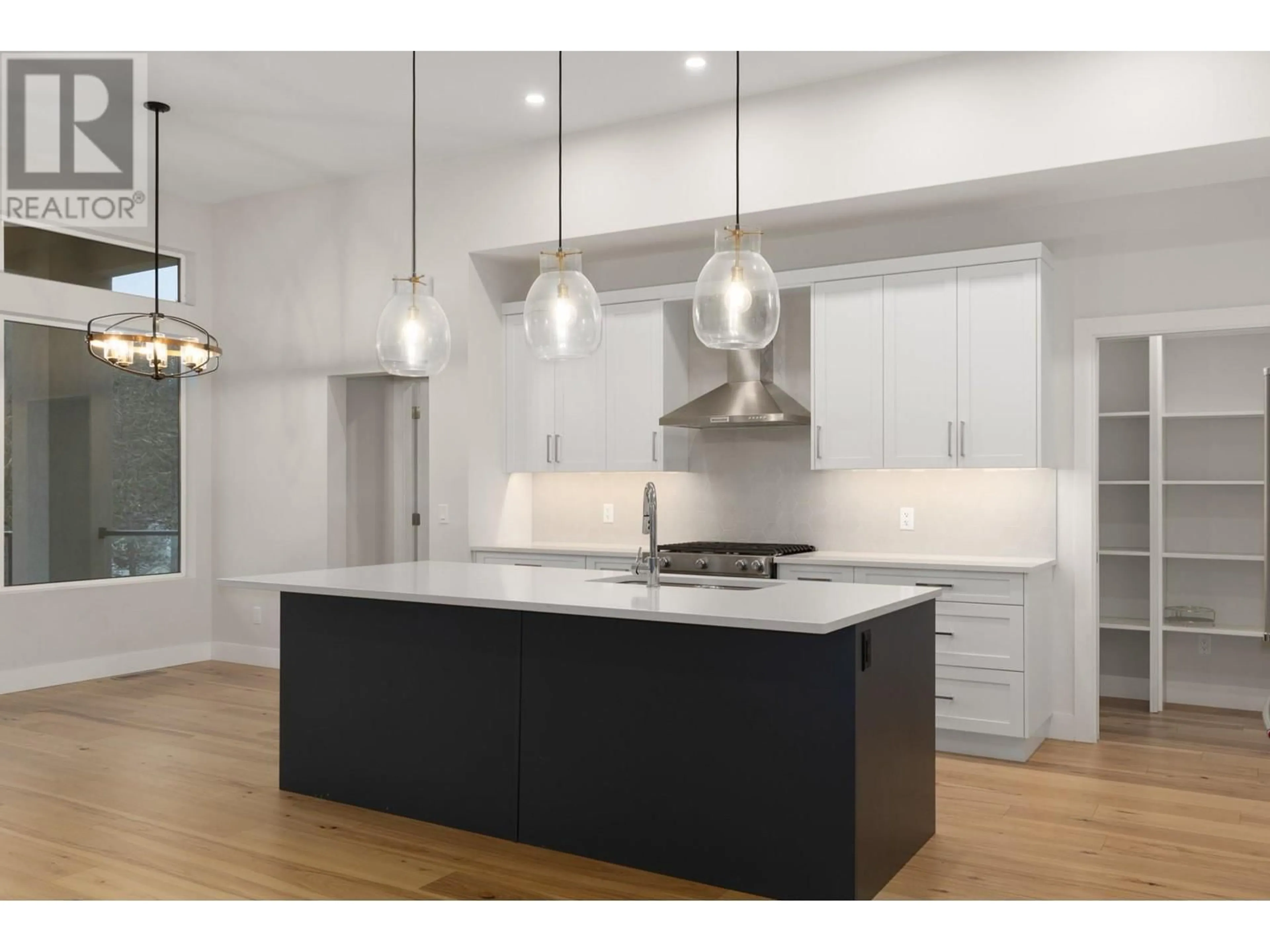 Open concept kitchen, wood/laminate floor for 1928 Northern Flicker Court, Kelowna British Columbia V1V0G3