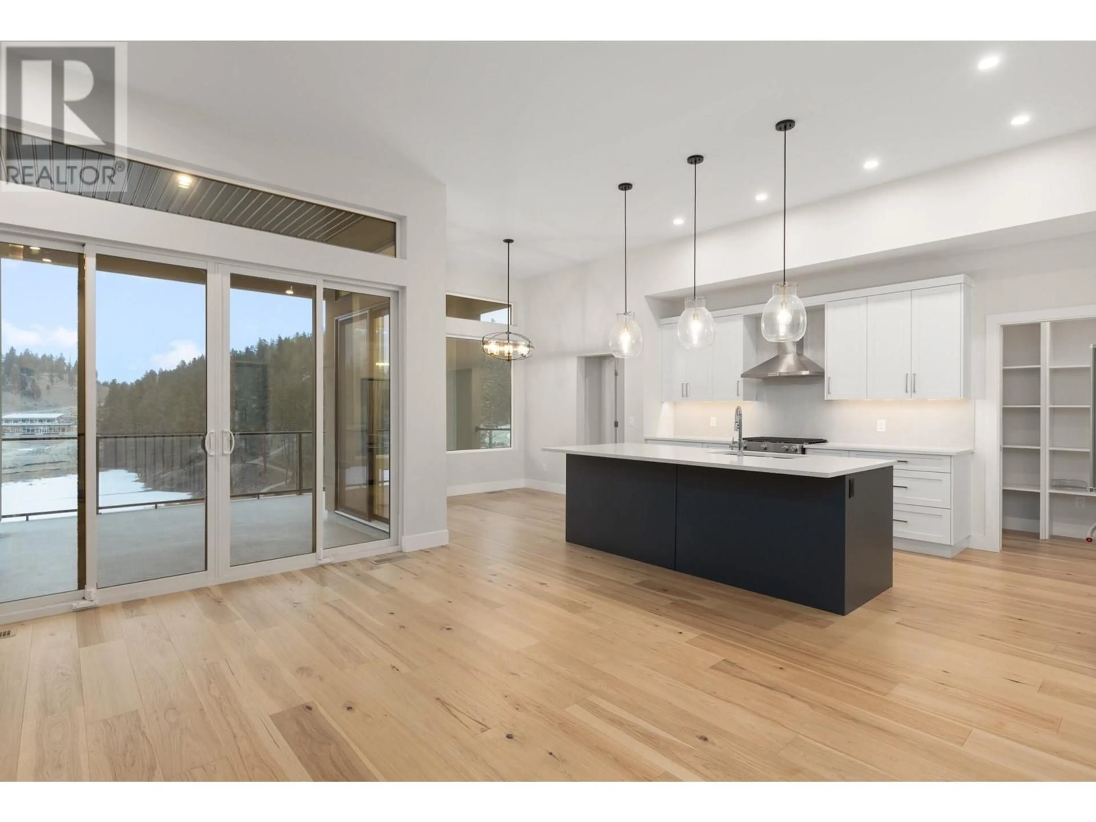 Open concept kitchen, wood/laminate floor for 1928 Northern Flicker Court, Kelowna British Columbia V1V0G3