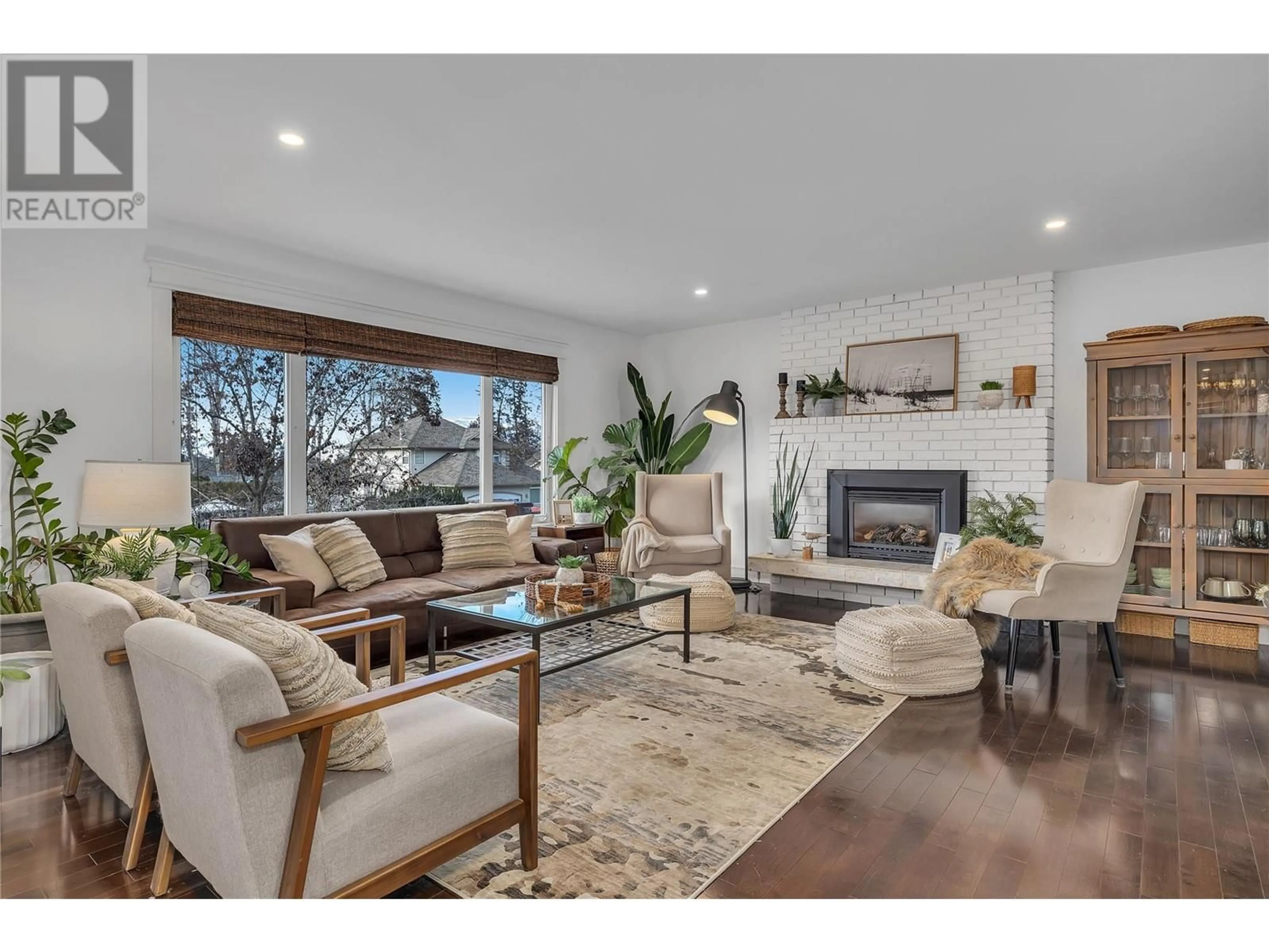 Living room with furniture, wood/laminate floor for 4645 Barton Street, Kelowna British Columbia V1W2B4