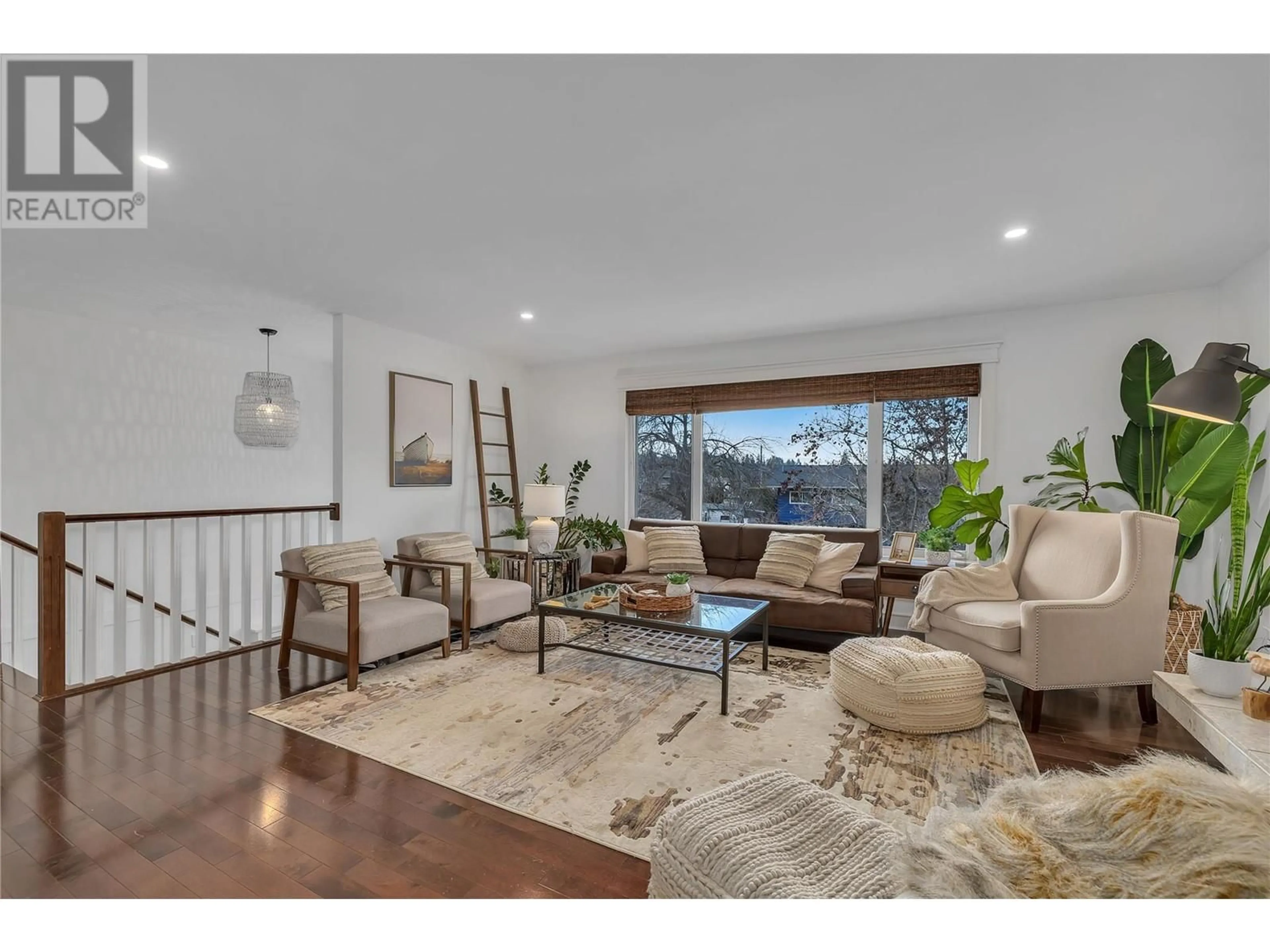 Living room with furniture, wood/laminate floor for 4645 Barton Street, Kelowna British Columbia V1W2B4