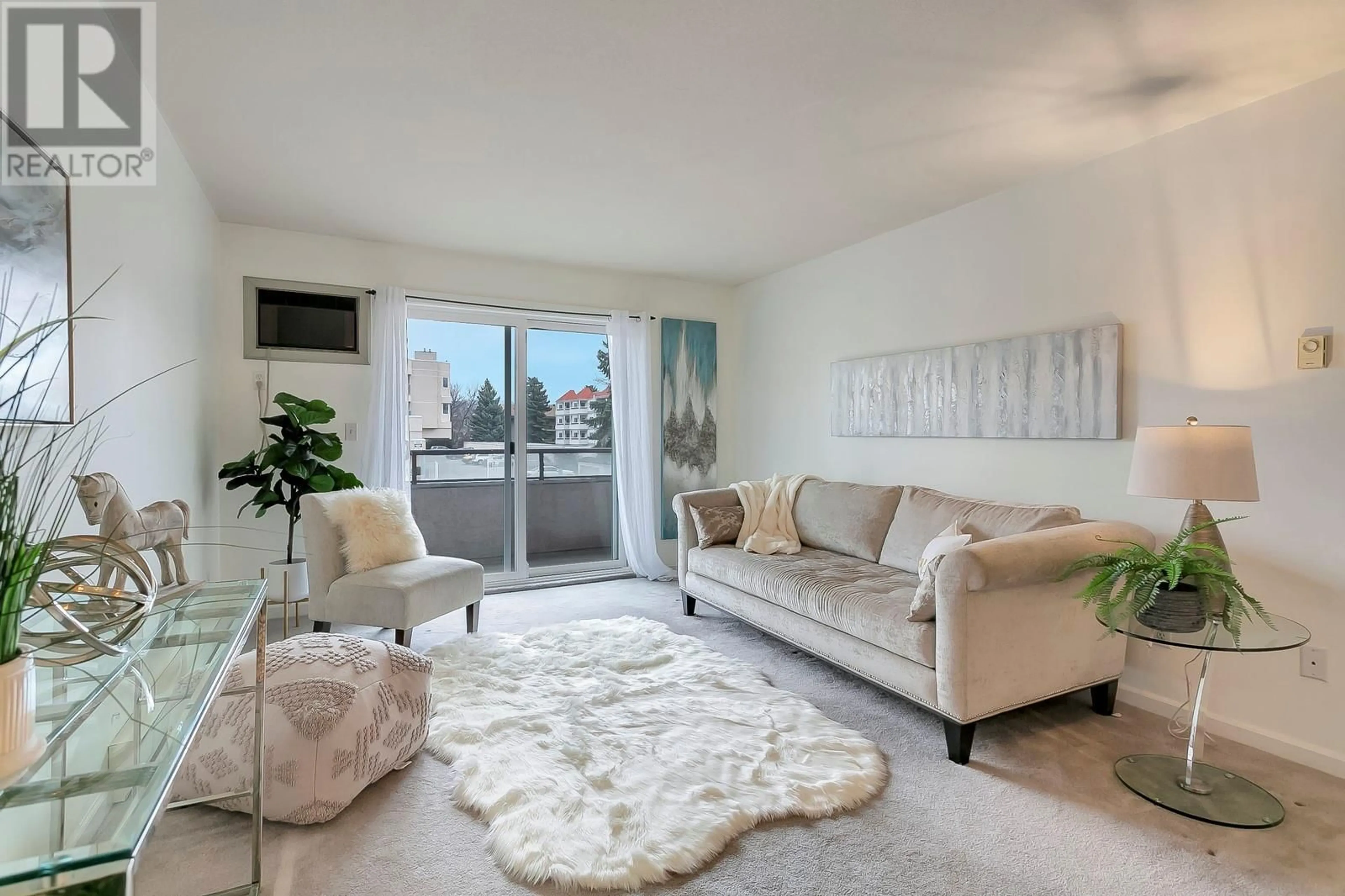 Living room with furniture, carpet floor for 993 KLO Road Unit# 101, Kelowna British Columbia V1Y9L2