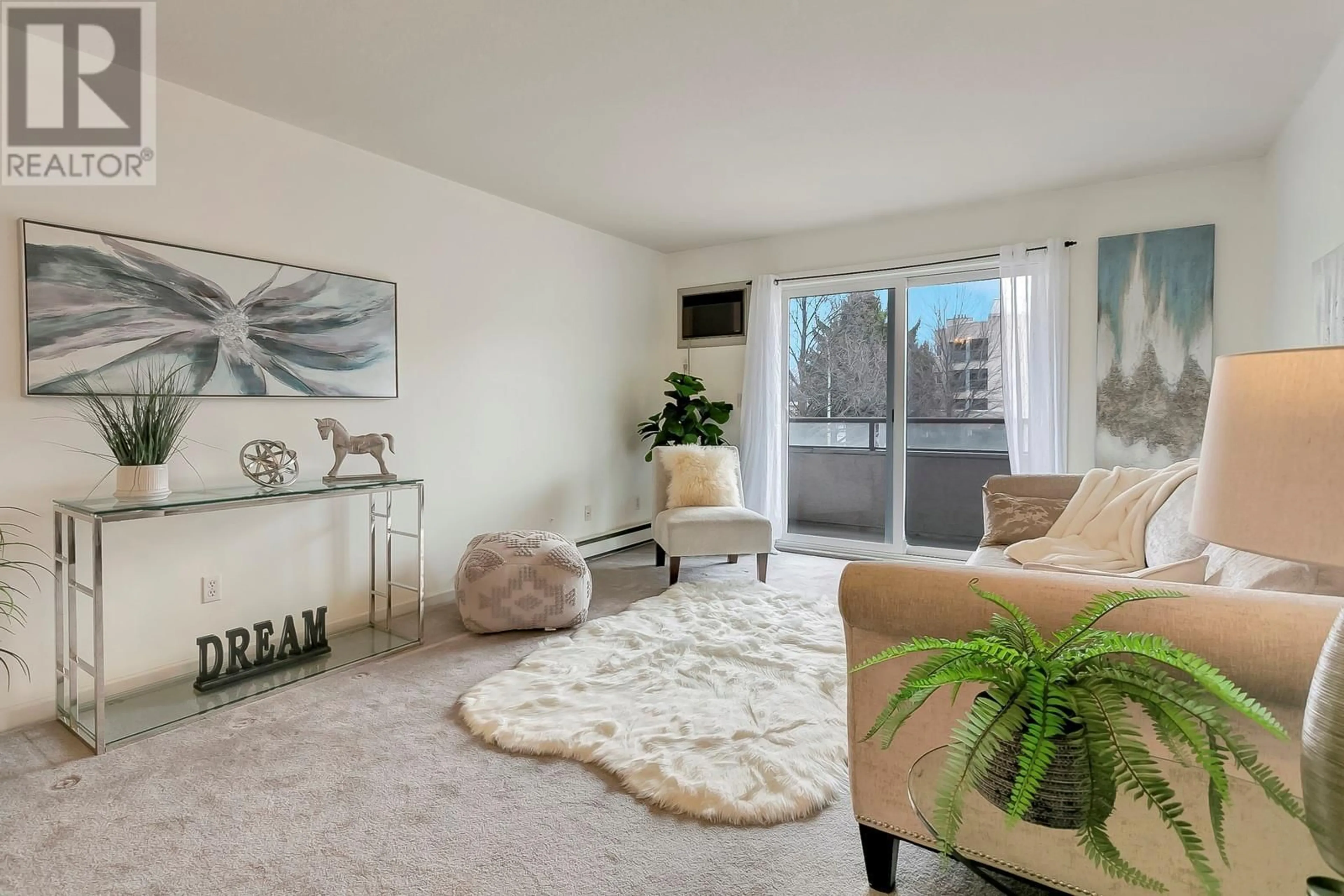 Living room with furniture, carpet floor for 993 KLO Road Unit# 101, Kelowna British Columbia V1Y9L2