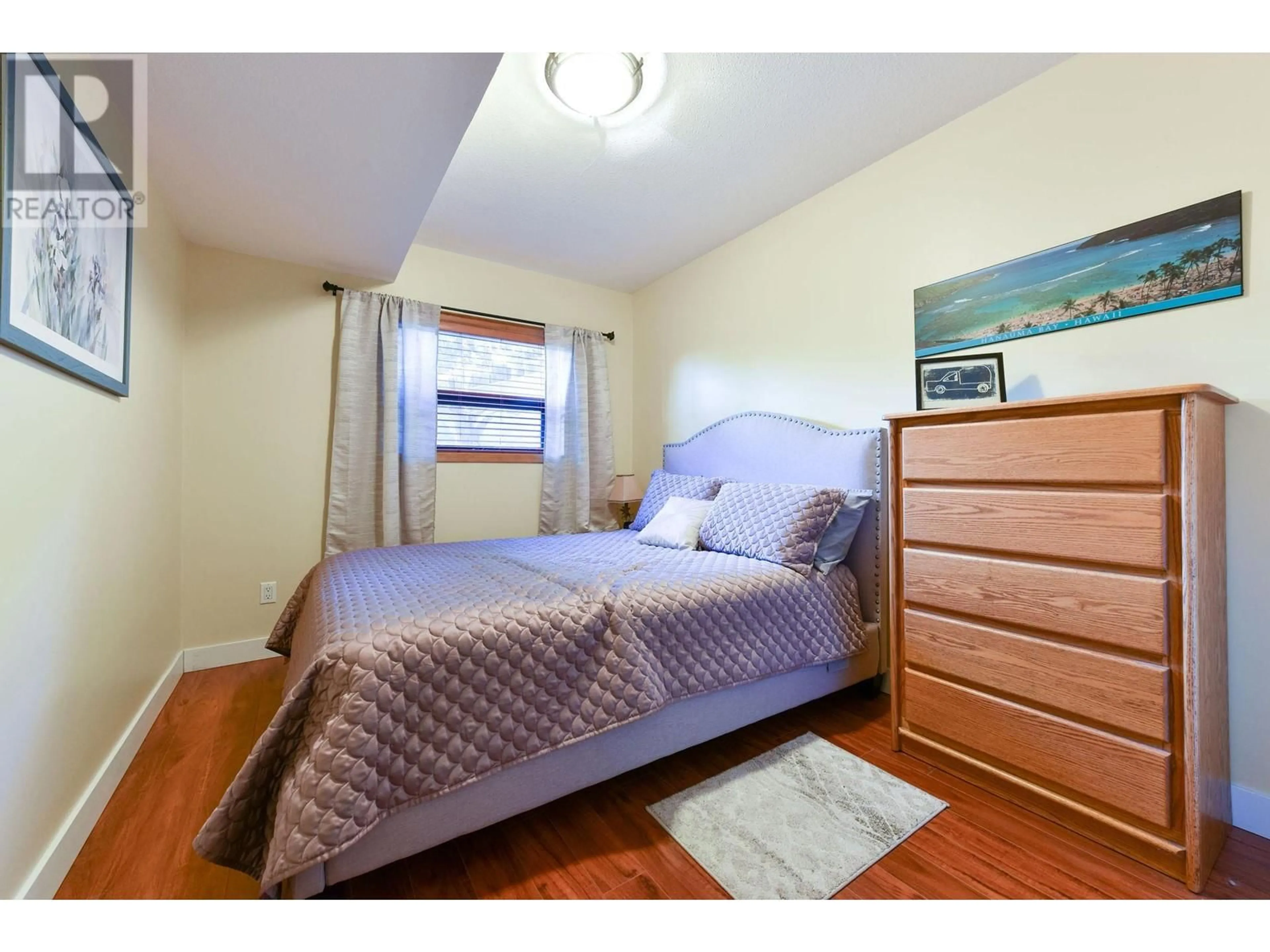 Bedroom with bed, wood/laminate floor for 124 Millar Place, Penticton British Columbia V2A8A1