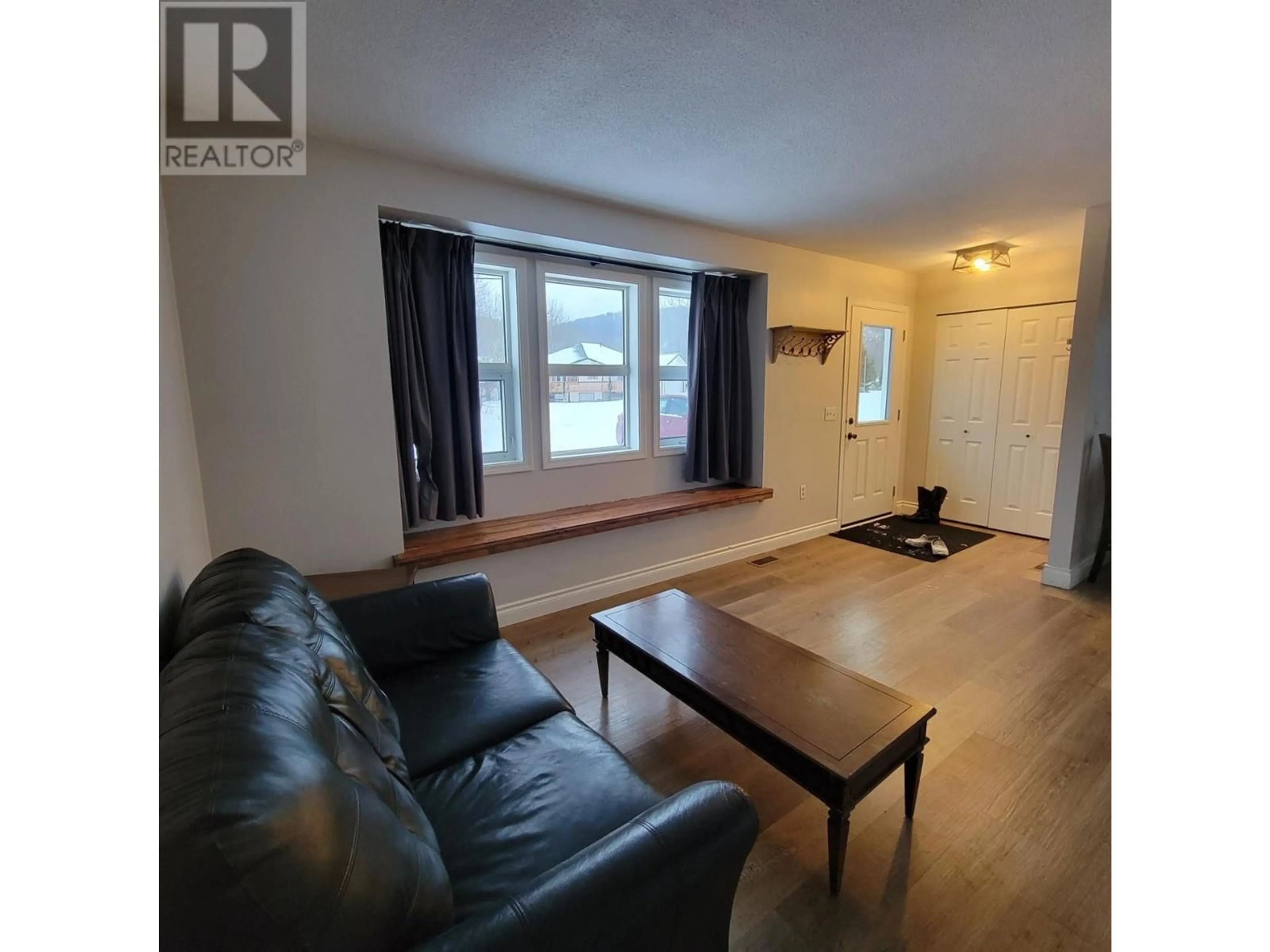 Living room with furniture, wood/laminate floor for 5201 42 Street, Chetwynd British Columbia V0C1J0