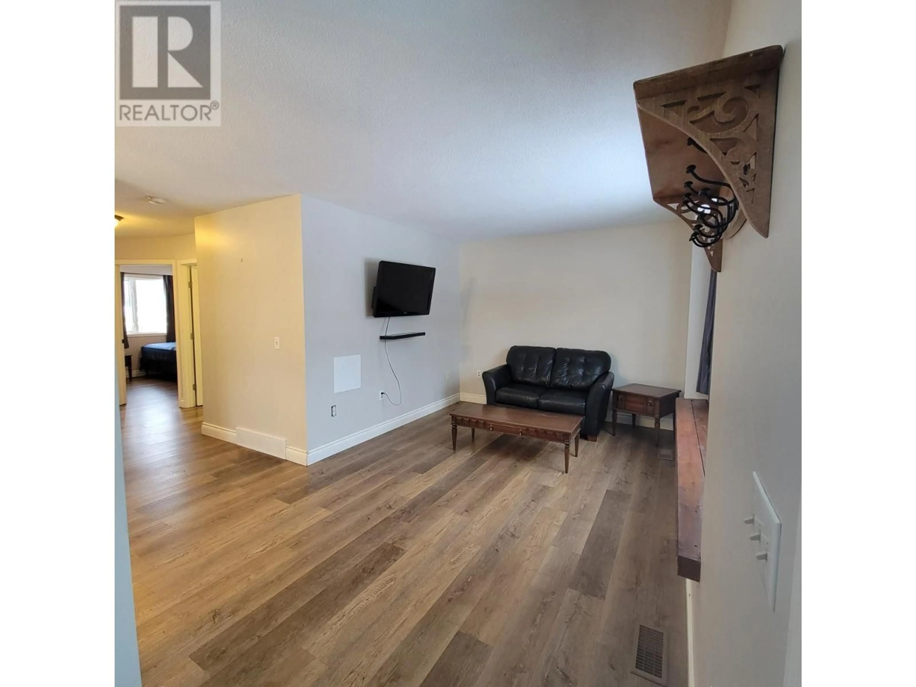 Living room with furniture, wood/laminate floor for 5201 42 Street, Chetwynd British Columbia V0C1J0