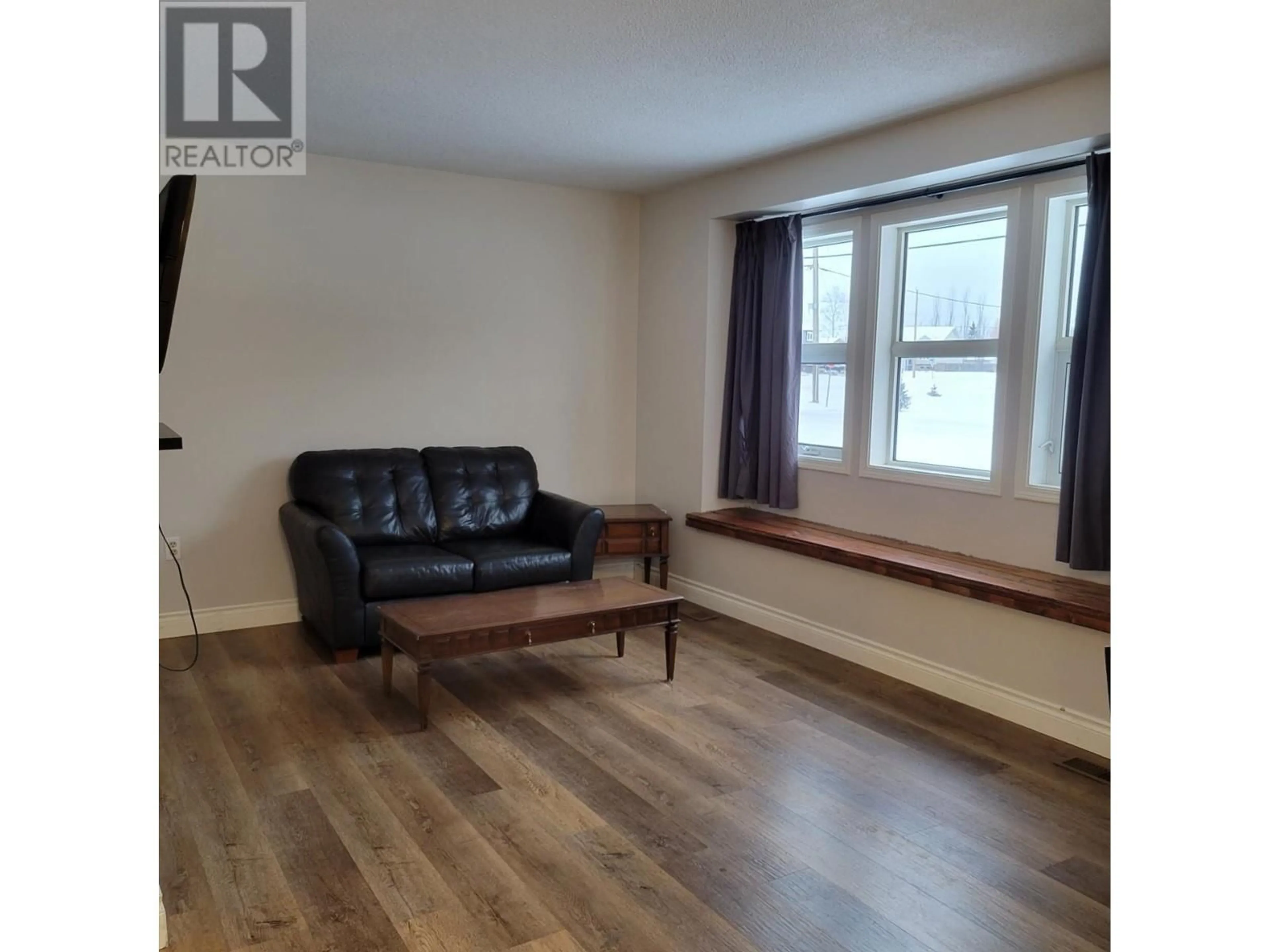 Living room with furniture, wood/laminate floor for 5201 42 Street, Chetwynd British Columbia V0C1J0