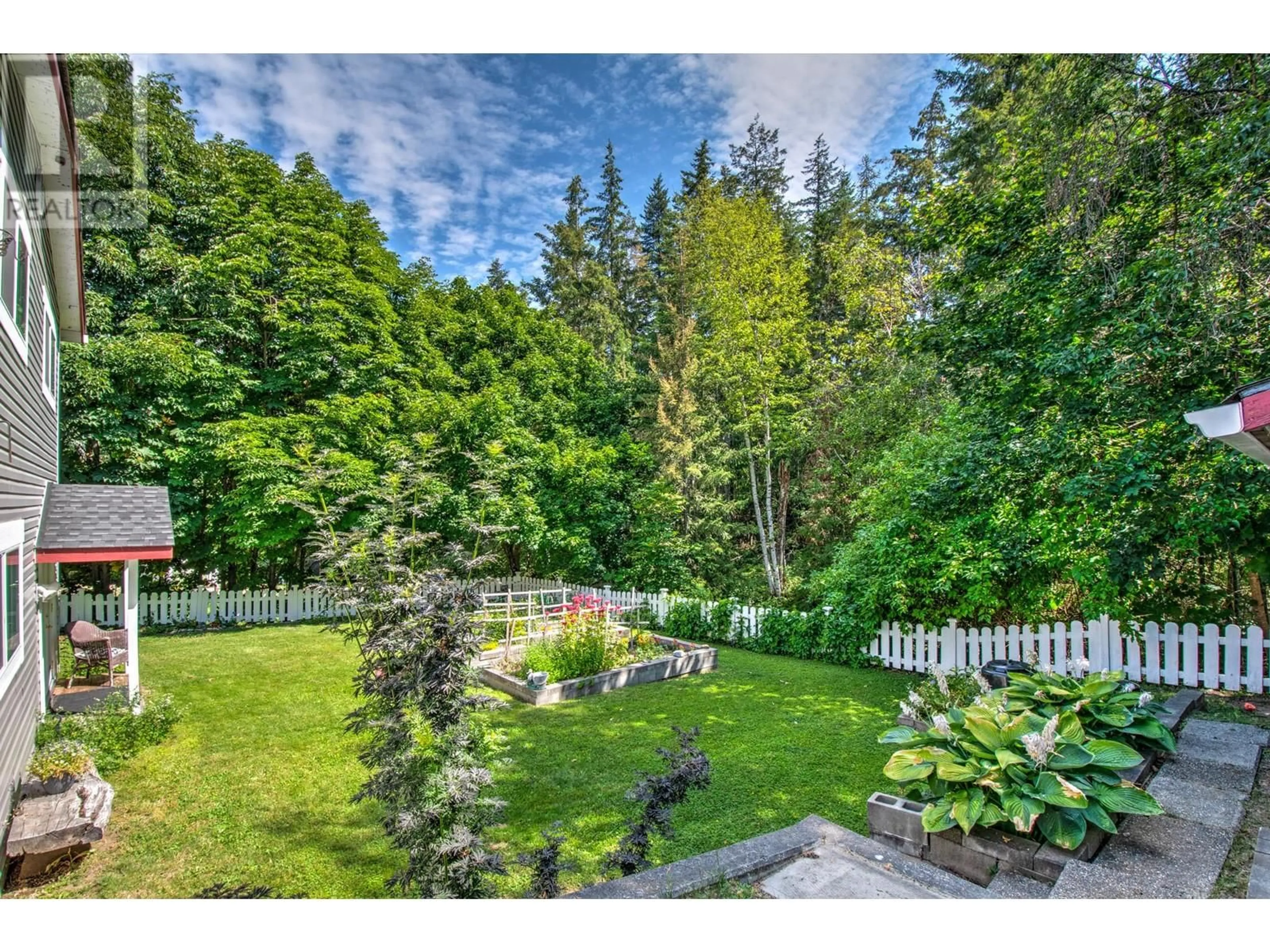 A pic from outside/outdoor area/front of a property/back of a property/a pic from drone, forest/trees view for 340 28 Street NE, Salmon Arm British Columbia V1E3N4