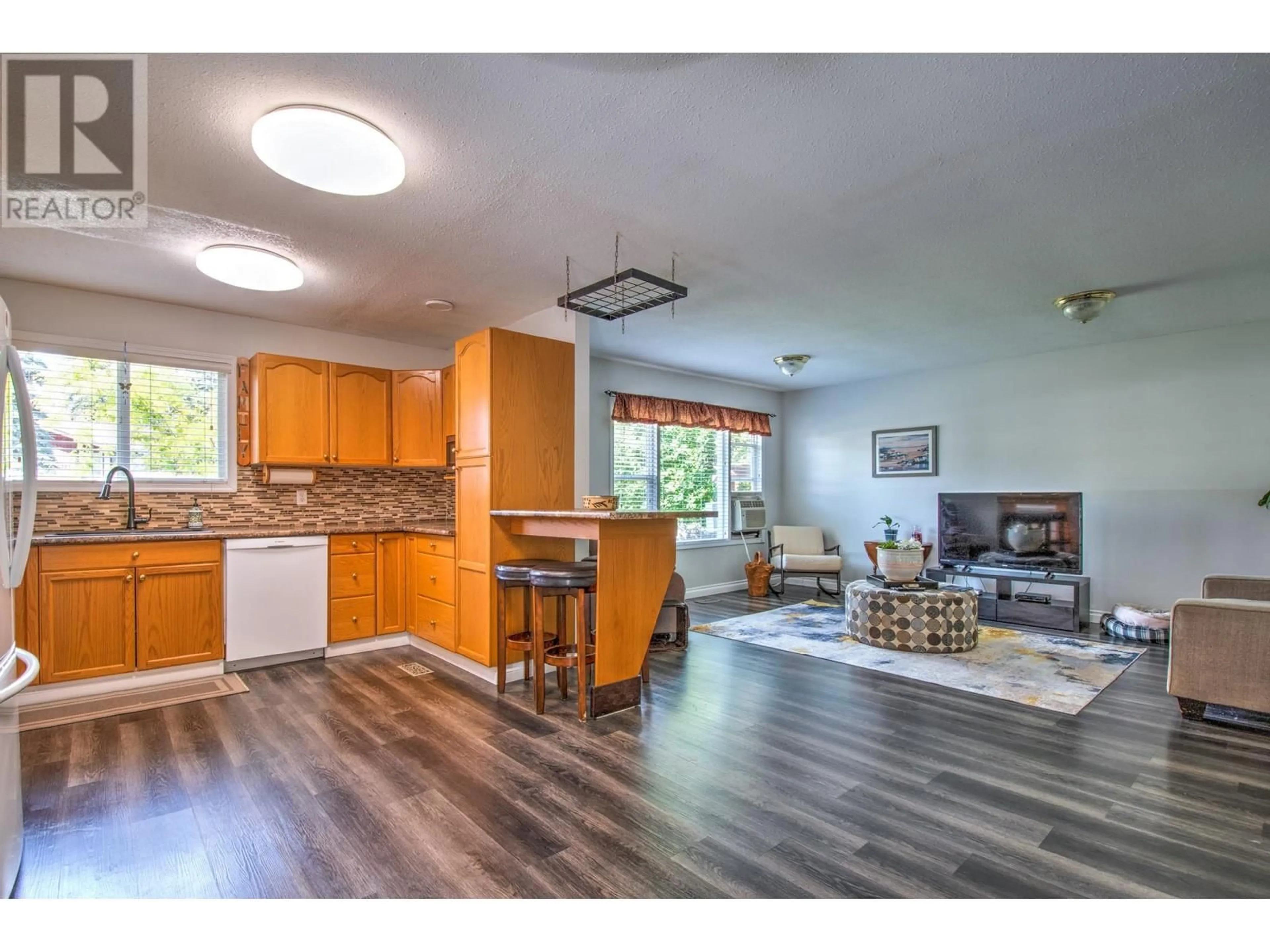 Open concept kitchen, wood/laminate floor for 340 28 Street NE, Salmon Arm British Columbia V1E3N4