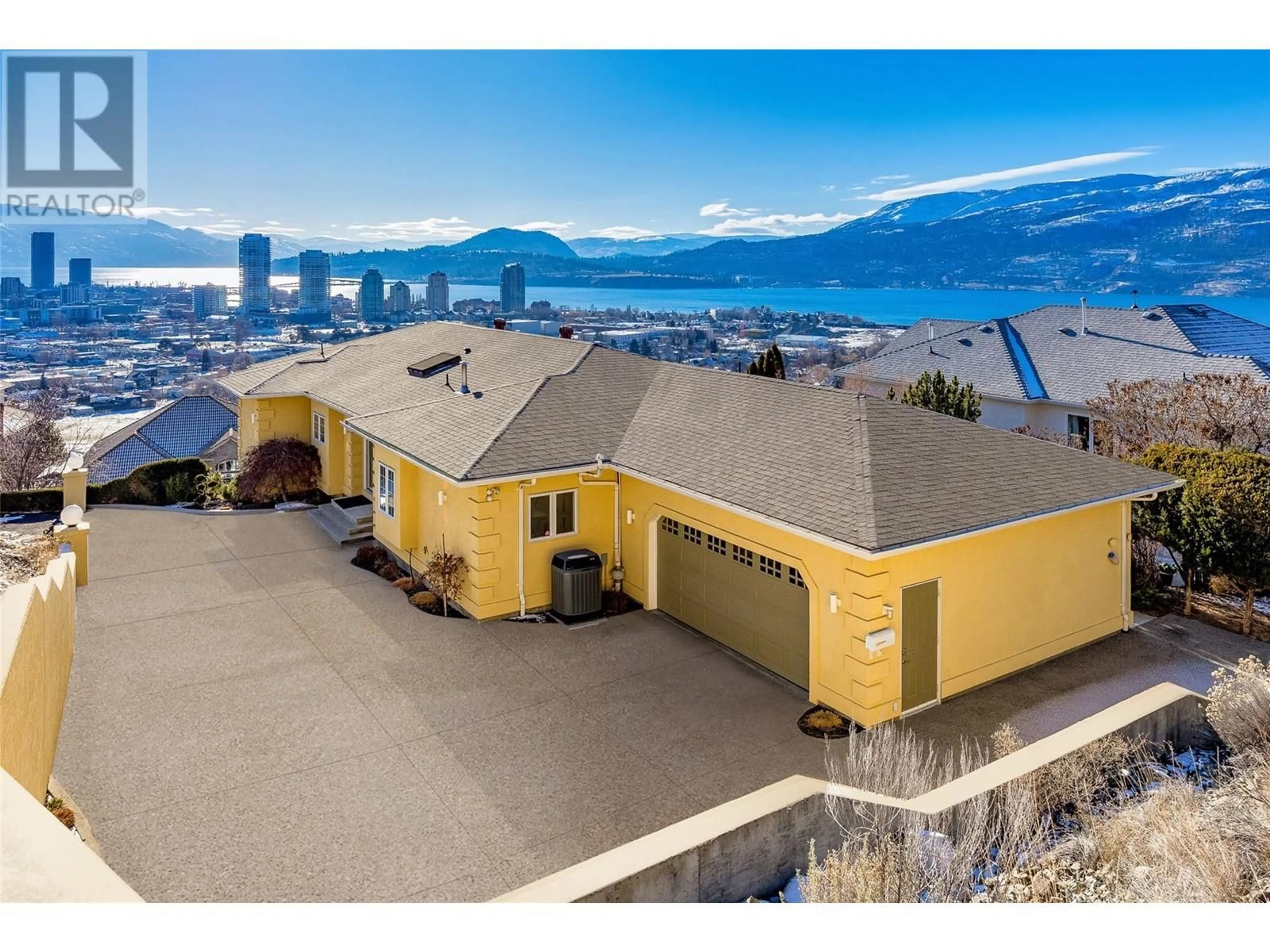 A pic from outside/outdoor area/front of a property/back of a property/a pic from drone, mountain view for 647 Royal Pine Drive, Kelowna British Columbia V1Y9K5