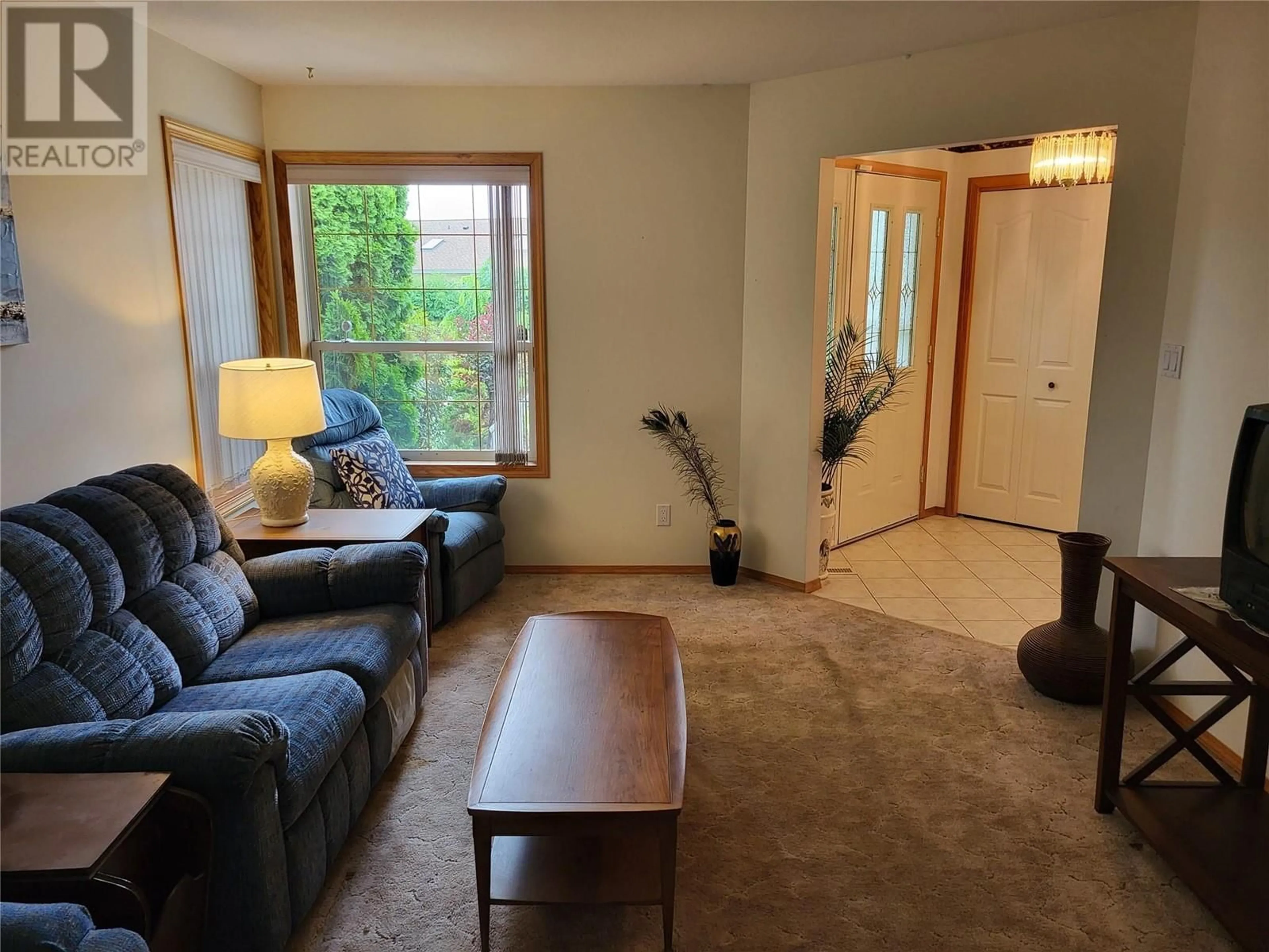 Living room with furniture, wood/laminate floor for 6184 Saint Martin Place, Oliver British Columbia V0H1T0