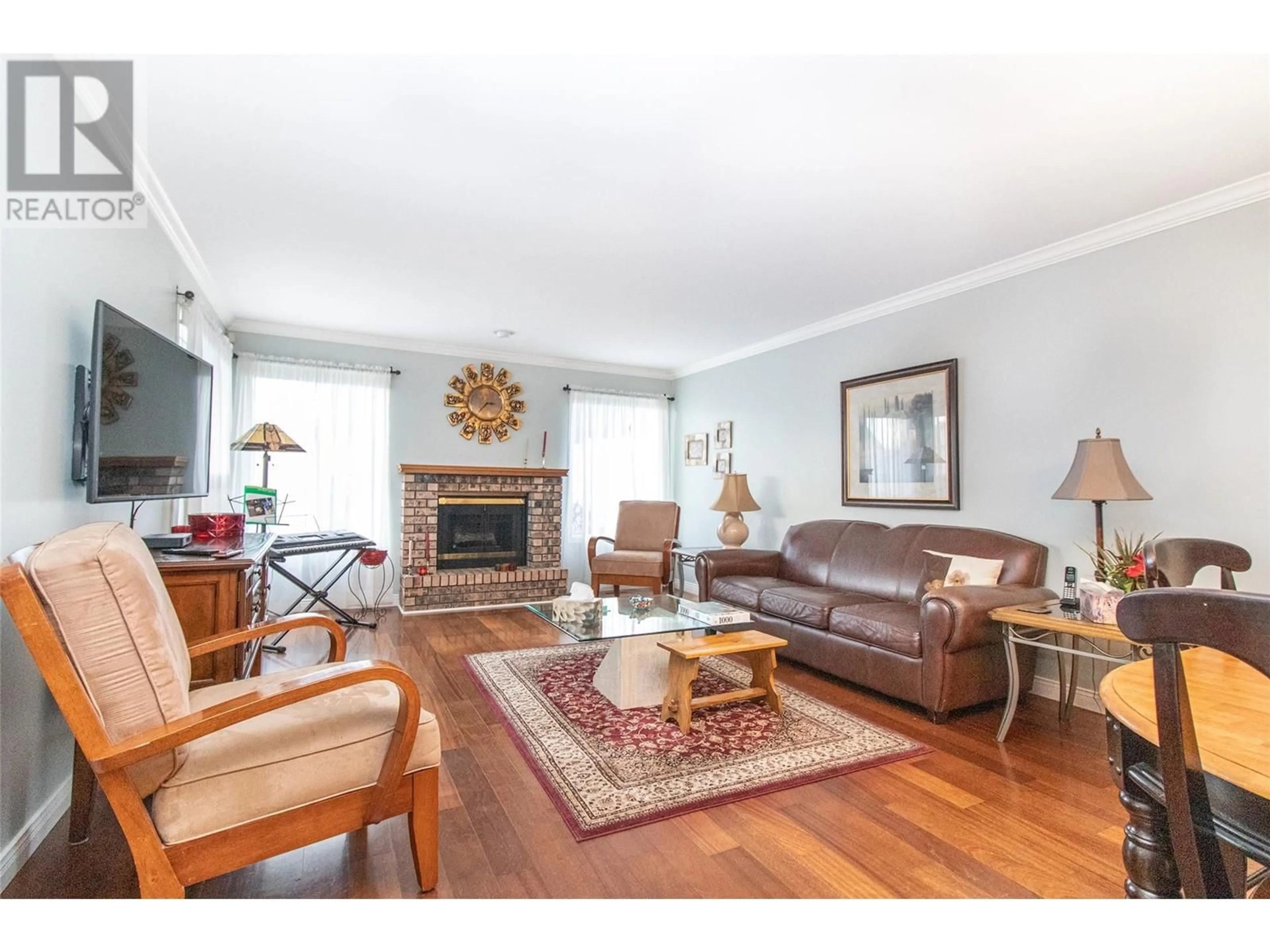 Living room with furniture, wood/laminate floor for 1101 Cameron Avenue Unit# 5, Kelowna British Columbia V1Y8V2