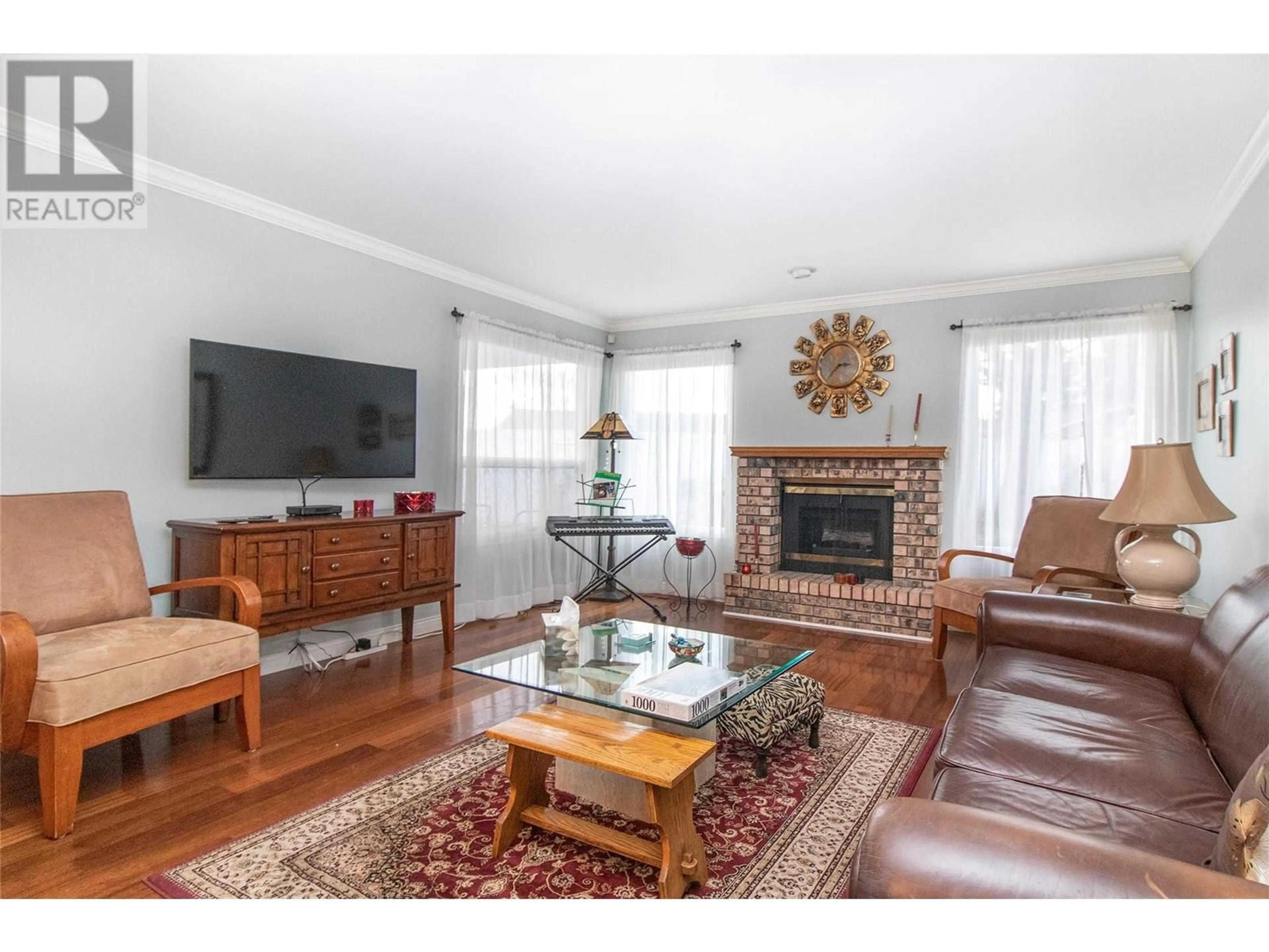 Living room with furniture, wood/laminate floor for 1101 Cameron Avenue Unit# 5, Kelowna British Columbia V1Y8V2