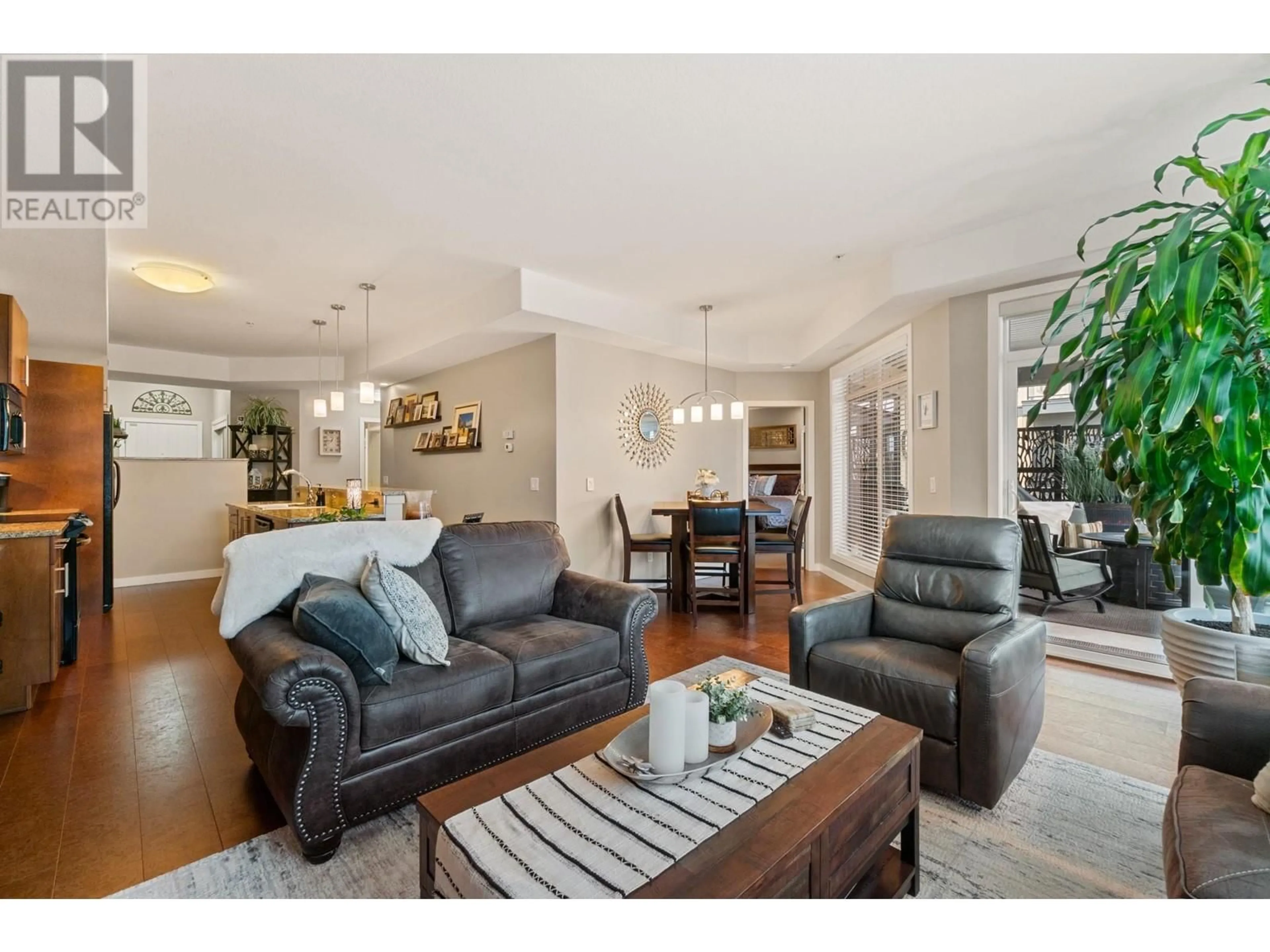 Living room with furniture, wood/laminate floor for 302 - 1933 AMBROSI ROAD, Kelowna British Columbia V1Y4S1