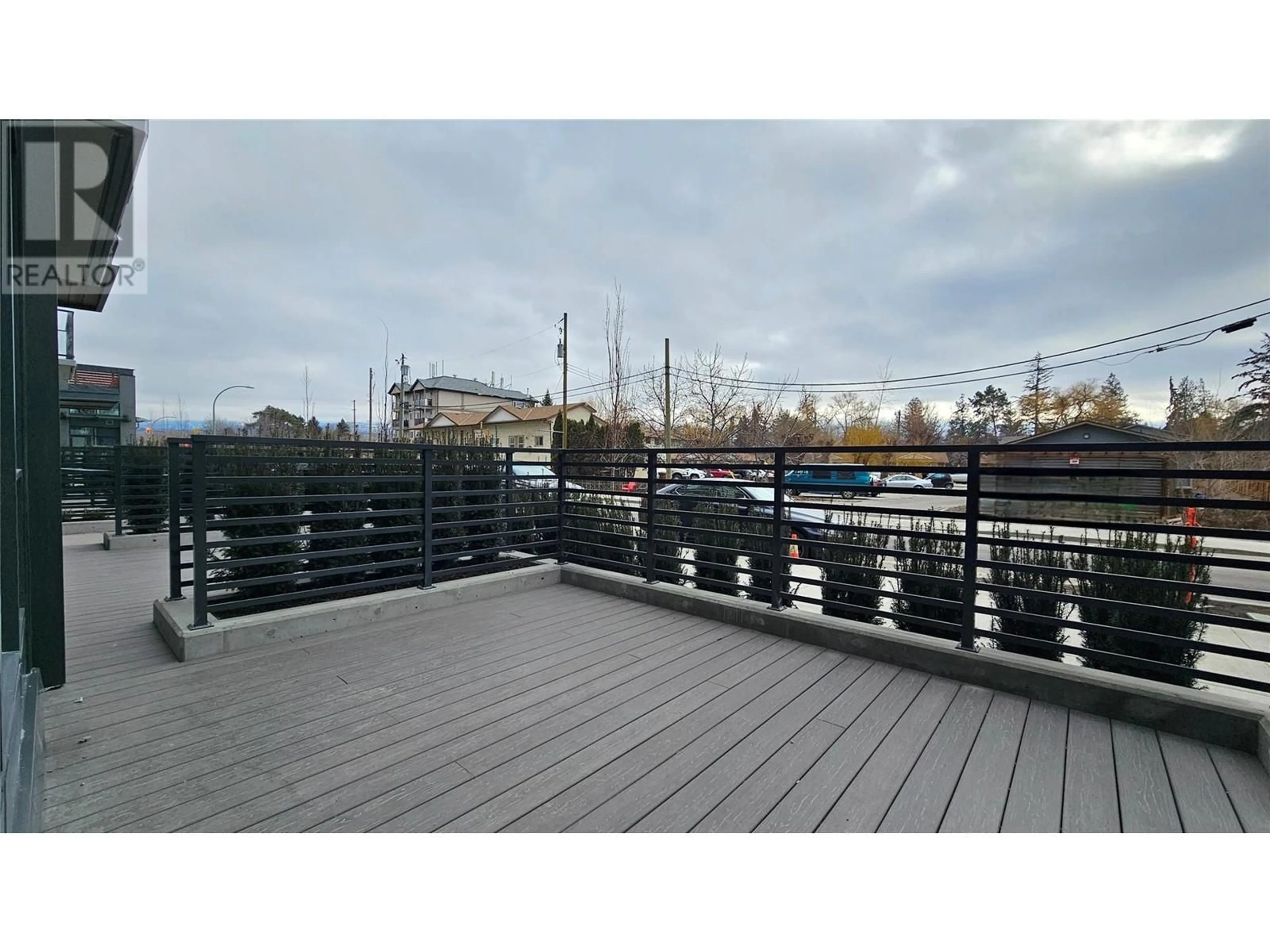 Patio, city buildings view from balcony for 3699 Capozzi Road Unit# 104, Kelowna British Columbia V1W0G3