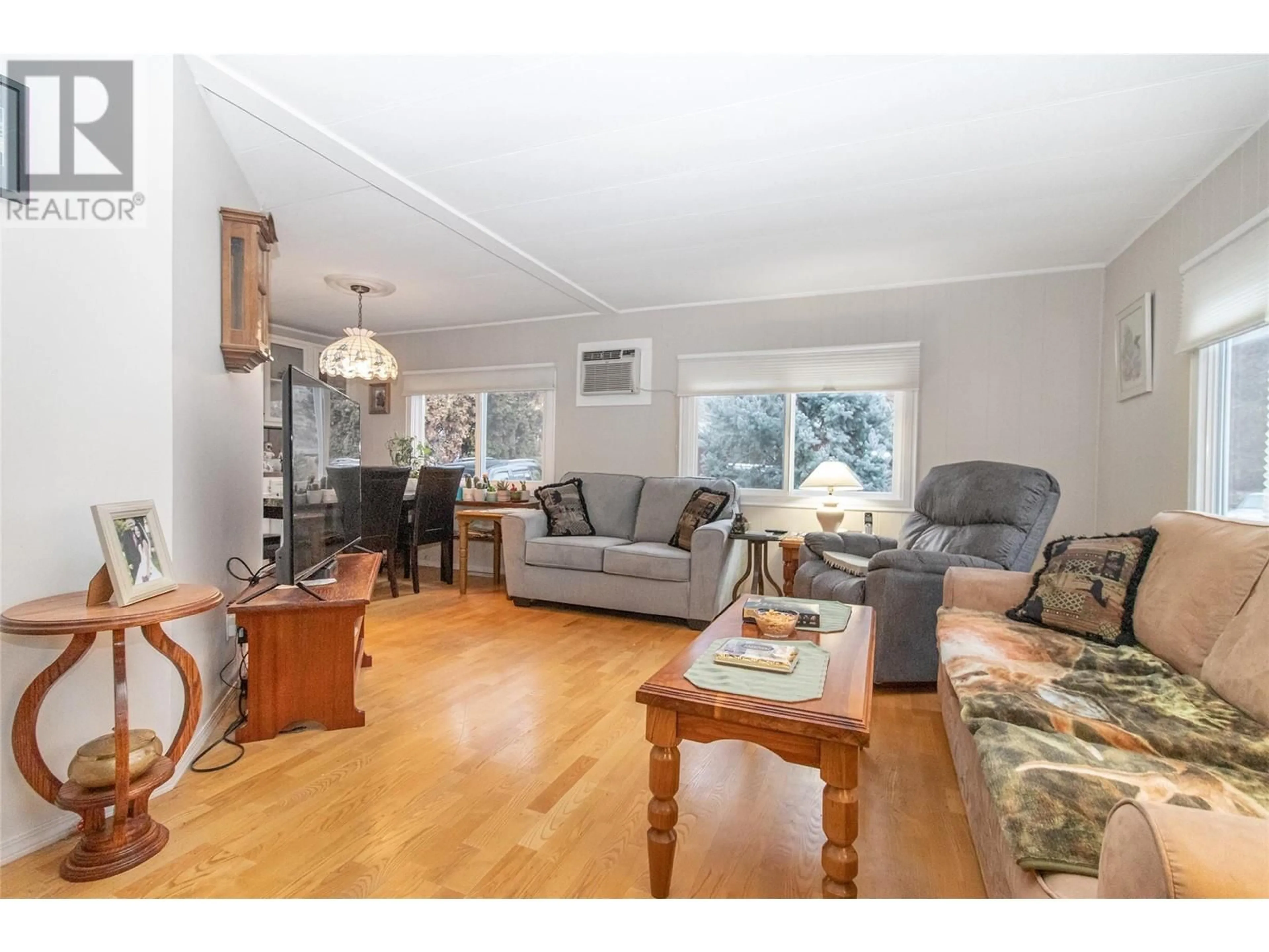 Living room with furniture, wood/laminate floor for 5432 Chidley Road Unit# 22, Peachland British Columbia V0H1X5