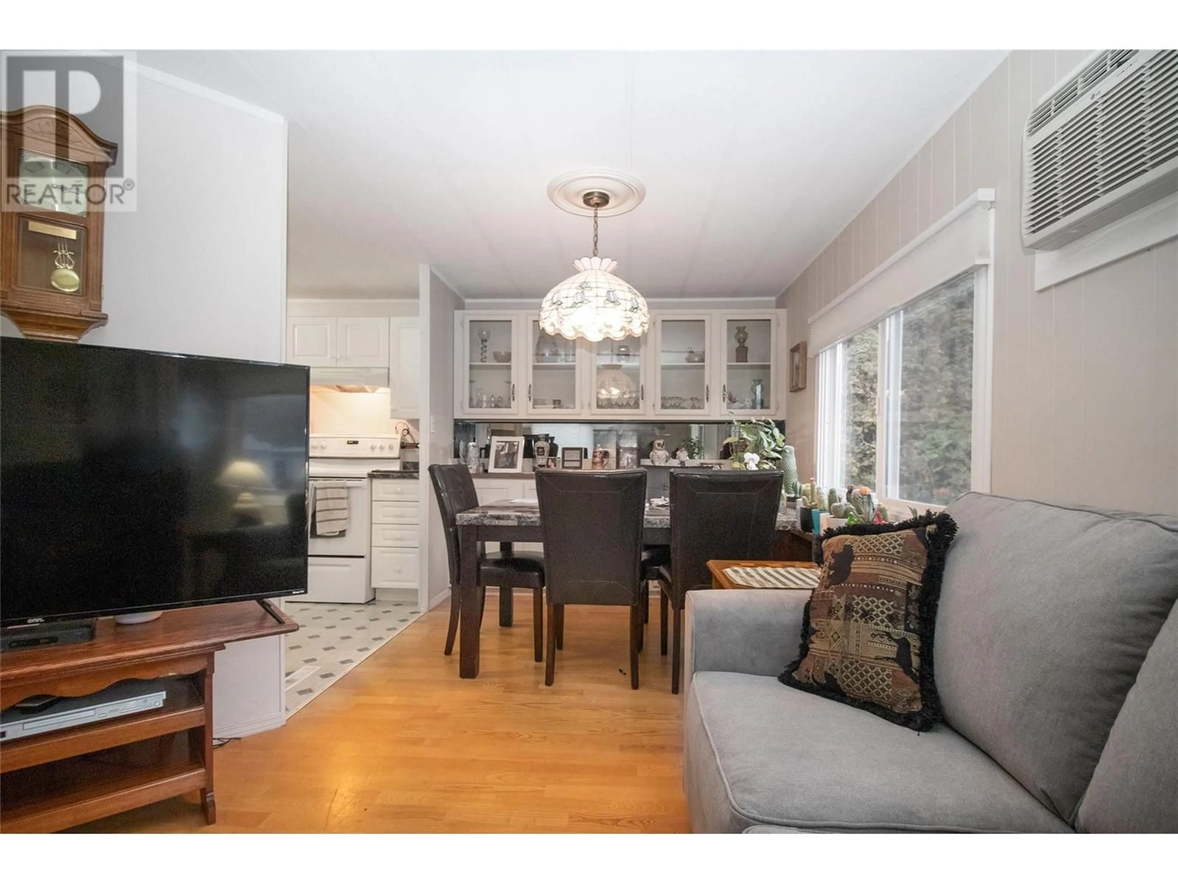 Living room with furniture, wood/laminate floor for 5432 Chidley Road Unit# 22, Peachland British Columbia V0H1X5