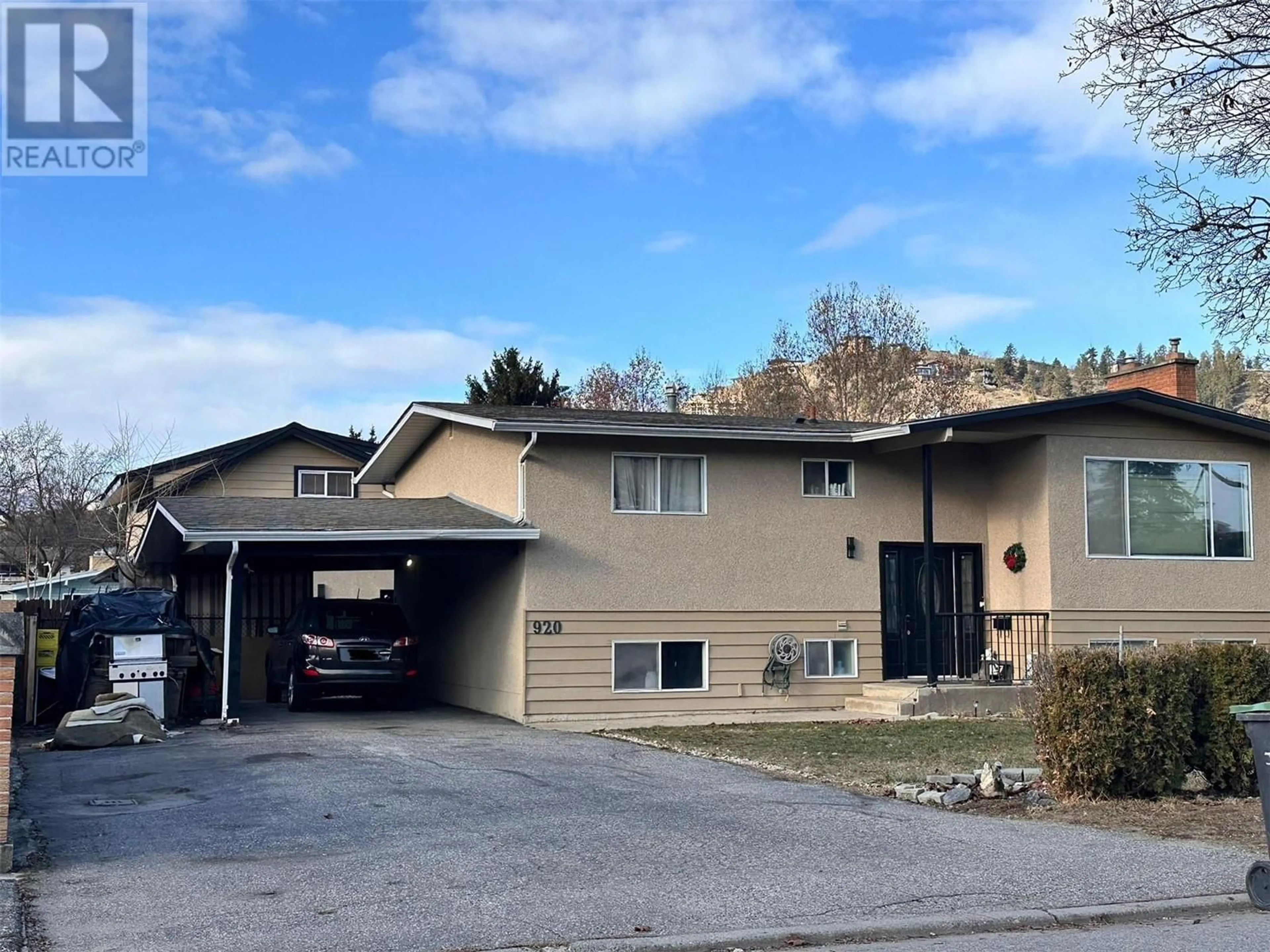 Home with vinyl exterior material, street for 920 Pitcairn Court, Kelowna British Columbia V1Y4E5