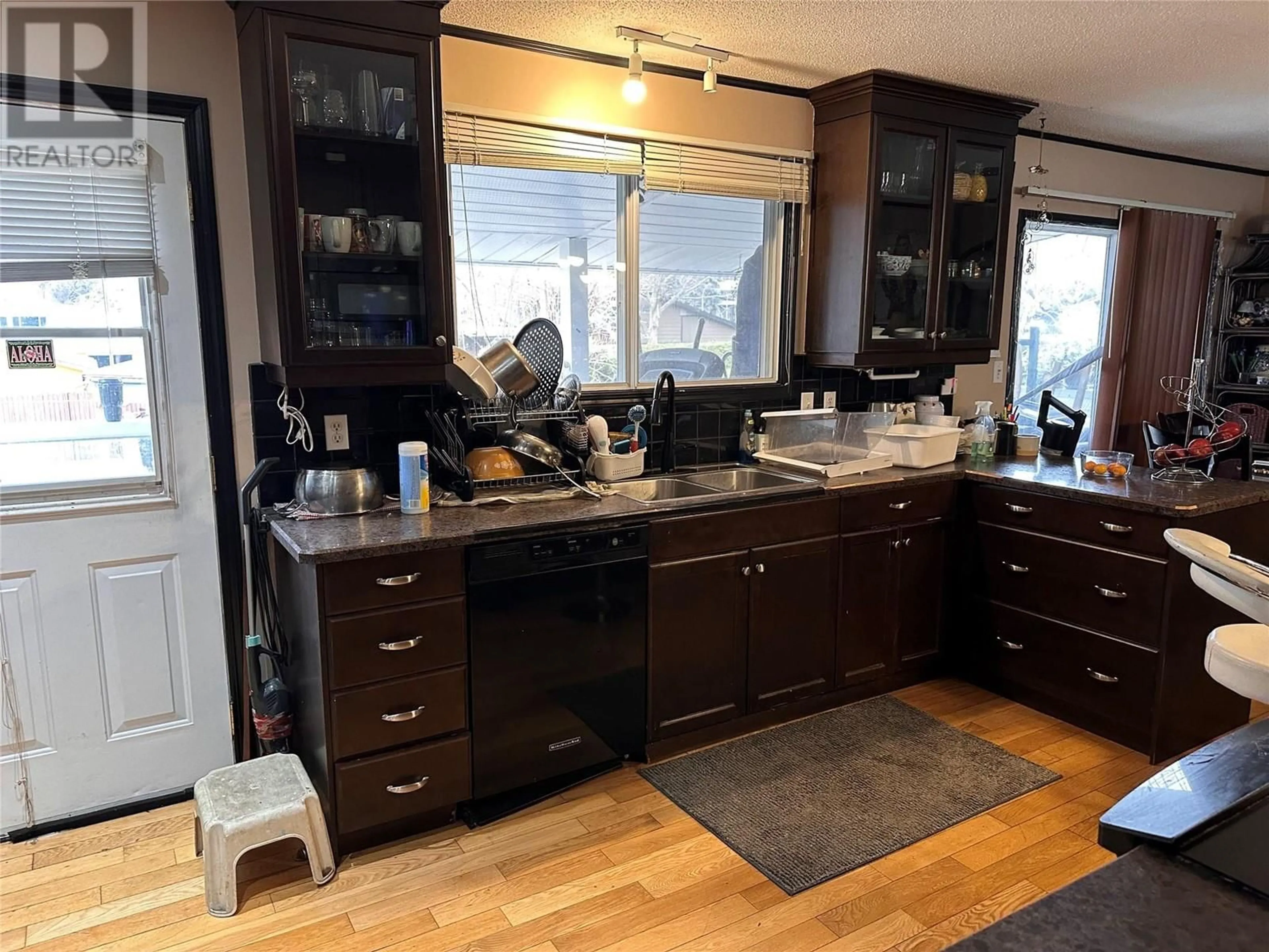 Open concept kitchen, wood/laminate floor for 920 Pitcairn Court, Kelowna British Columbia V1Y4E5