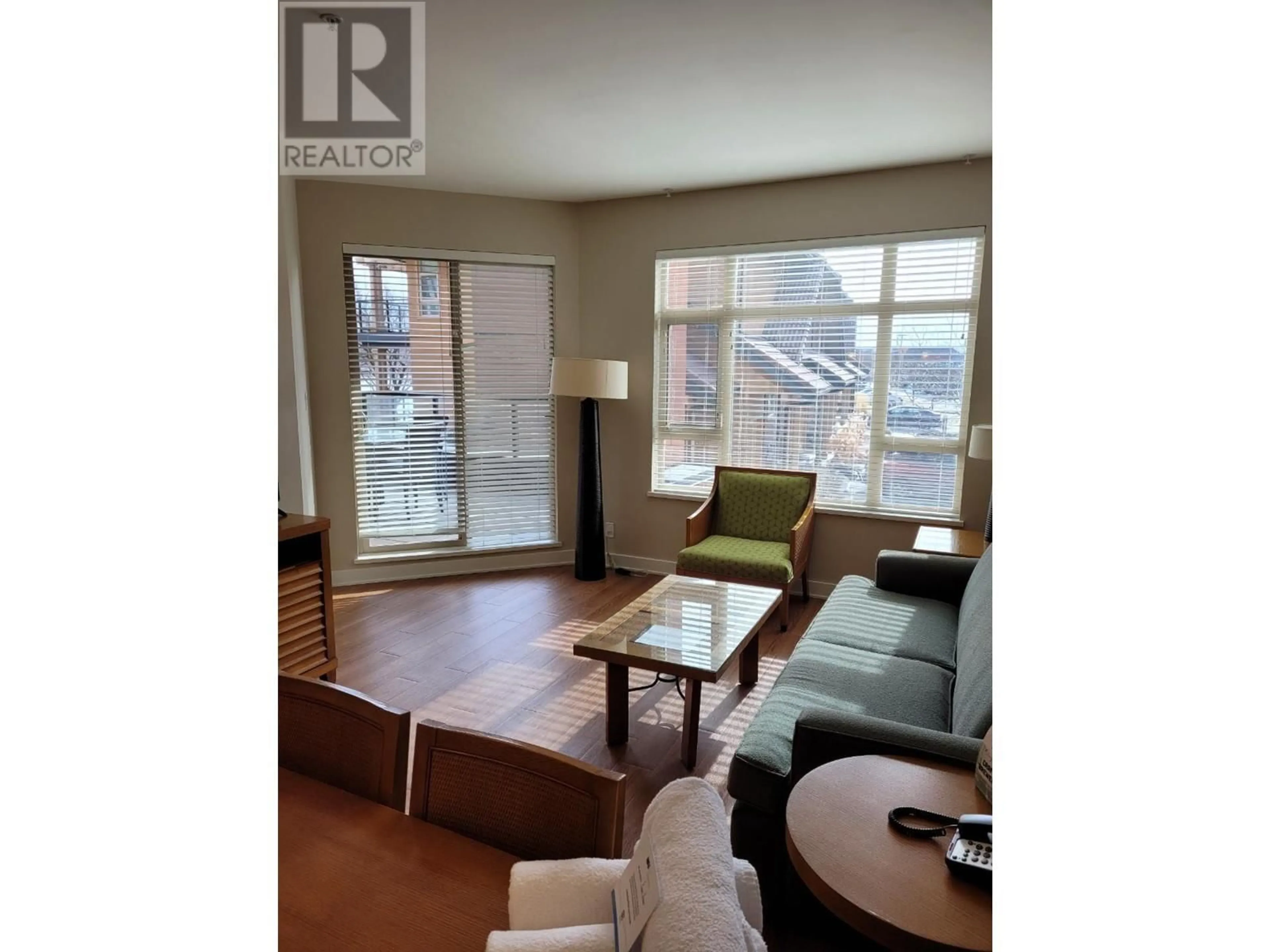 Living room with furniture, wood/laminate floor for 328 - 15 PARK PLACE, Osoyoos British Columbia V0H1V0