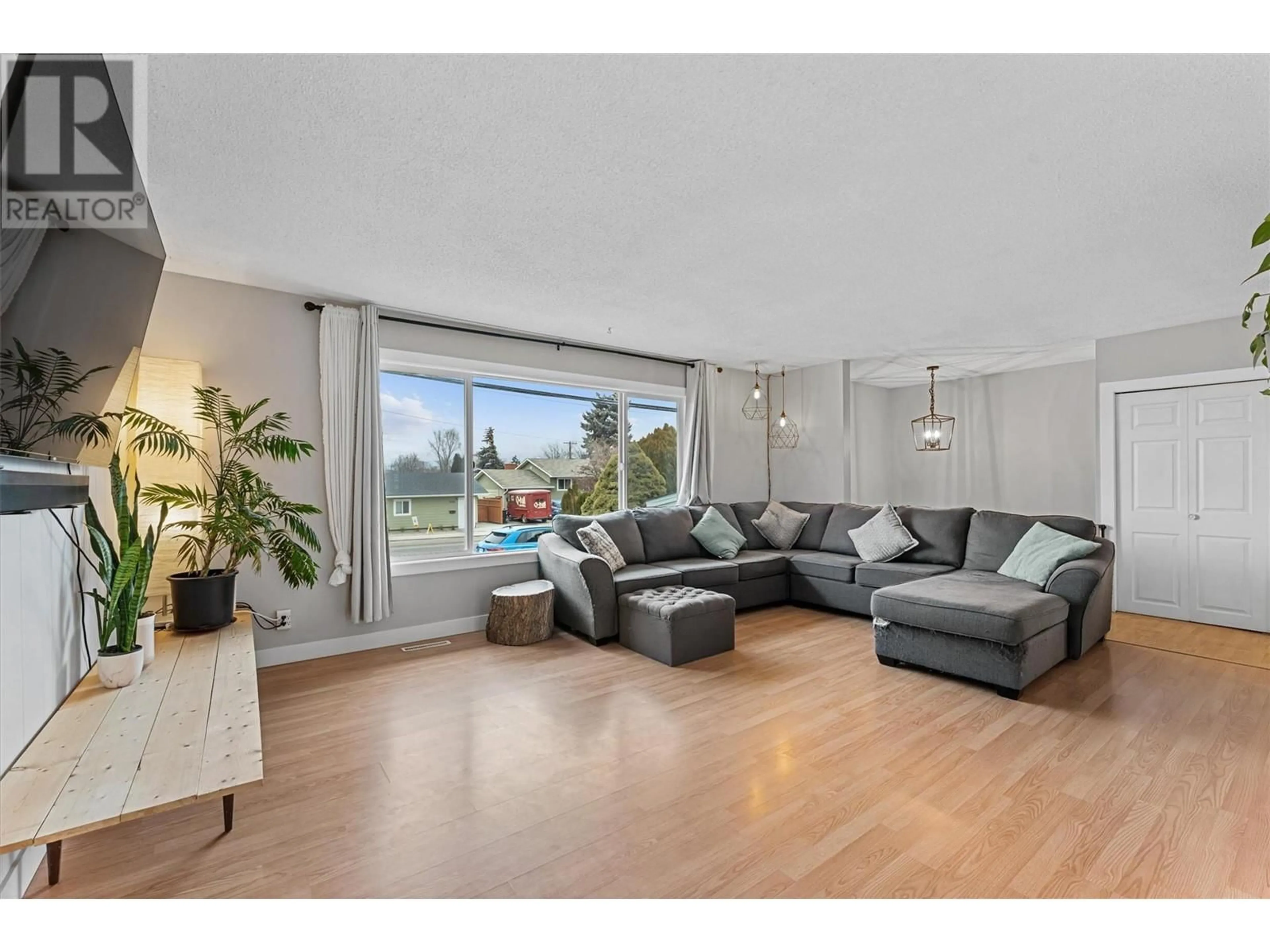 Living room with furniture, wood/laminate floor for 345 Holbrook Road E, Kelowna British Columbia V1X1S7