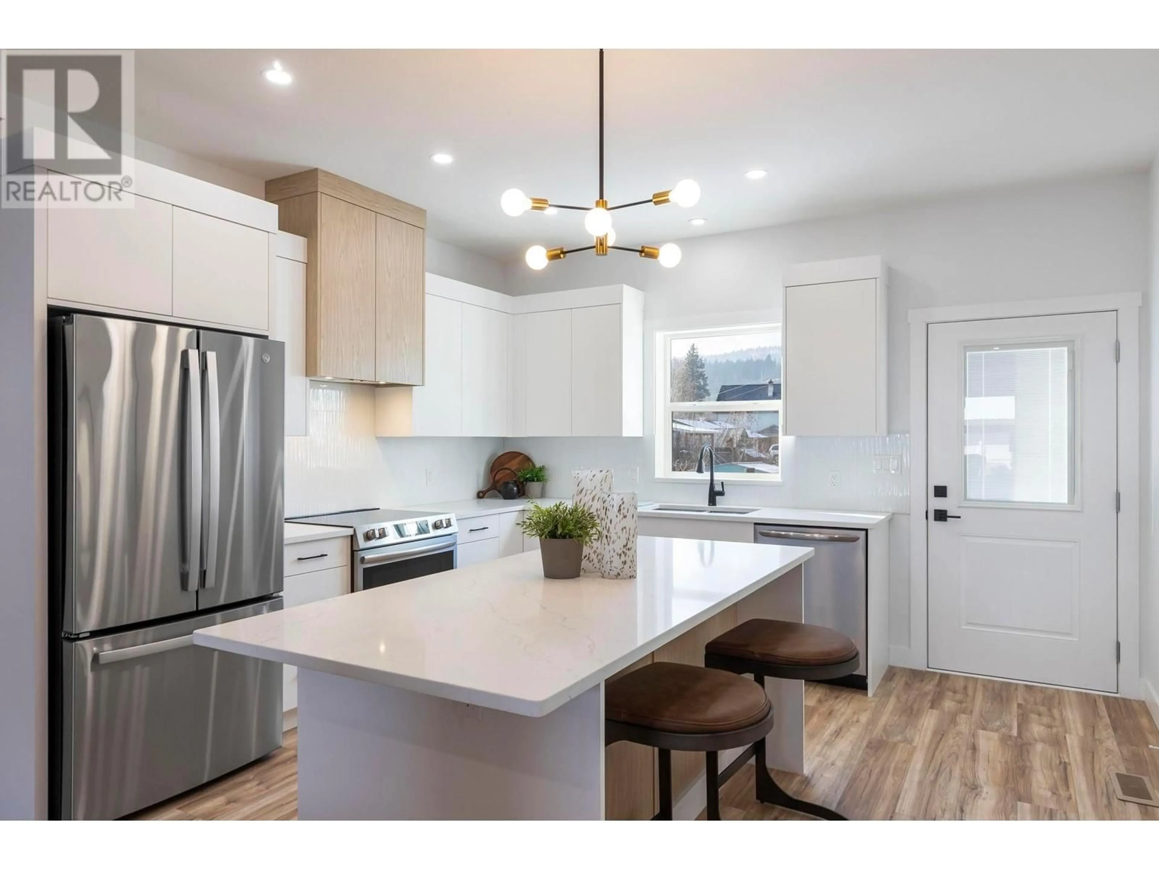 Open concept kitchen, wood/laminate floor for 1206 Woods Lane, Enderby British Columbia V0E1V2