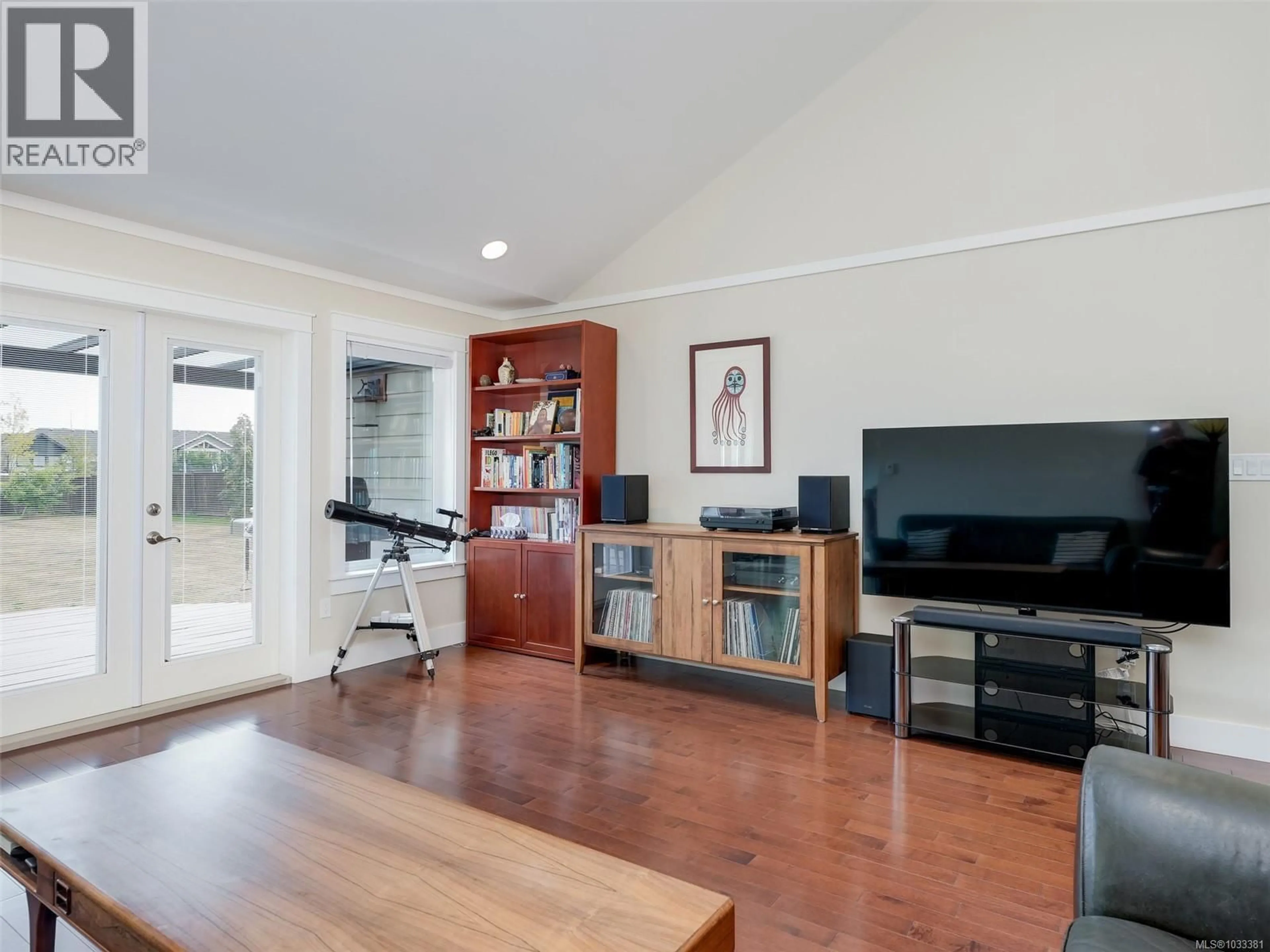 Living room with furniture, wood/laminate floor for 9173 BASSWOOD ROAD, North Saanich British Columbia V8L3W8