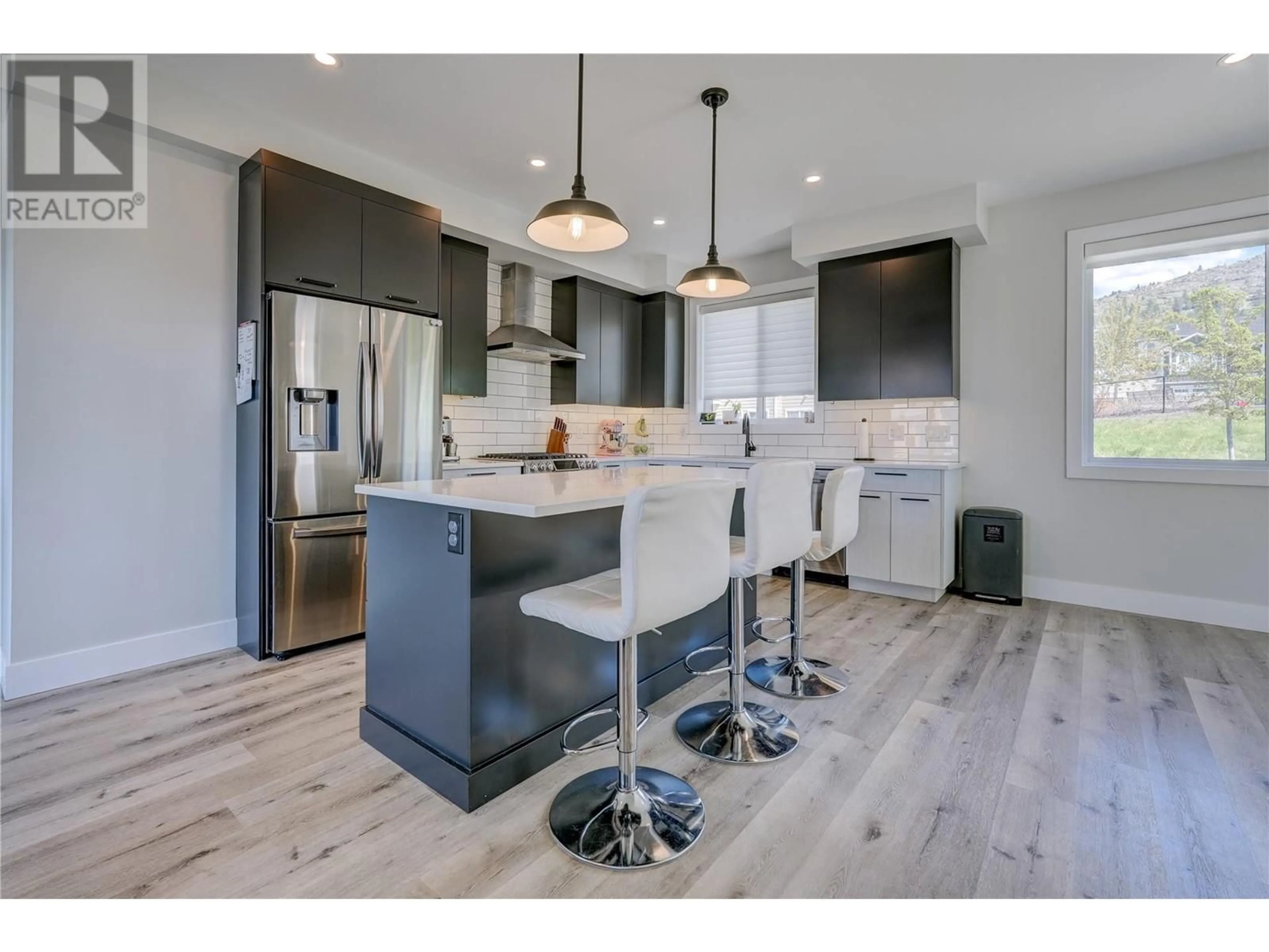 Open concept kitchen, wood/laminate floor for 1001 Antler Drive Unit# 101, Penticton British Columbia V2A0C8