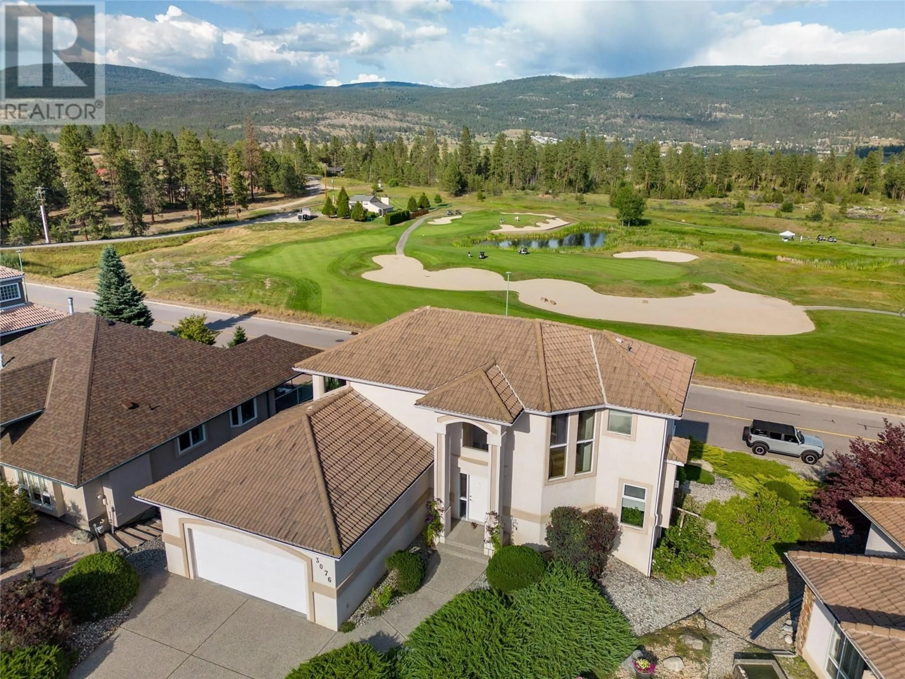 A pic from outside/outdoor area/front of a property/back of a property/a pic from drone, mountain view for 3076 Quail Crescent, Kelowna British Columbia V1V2A1