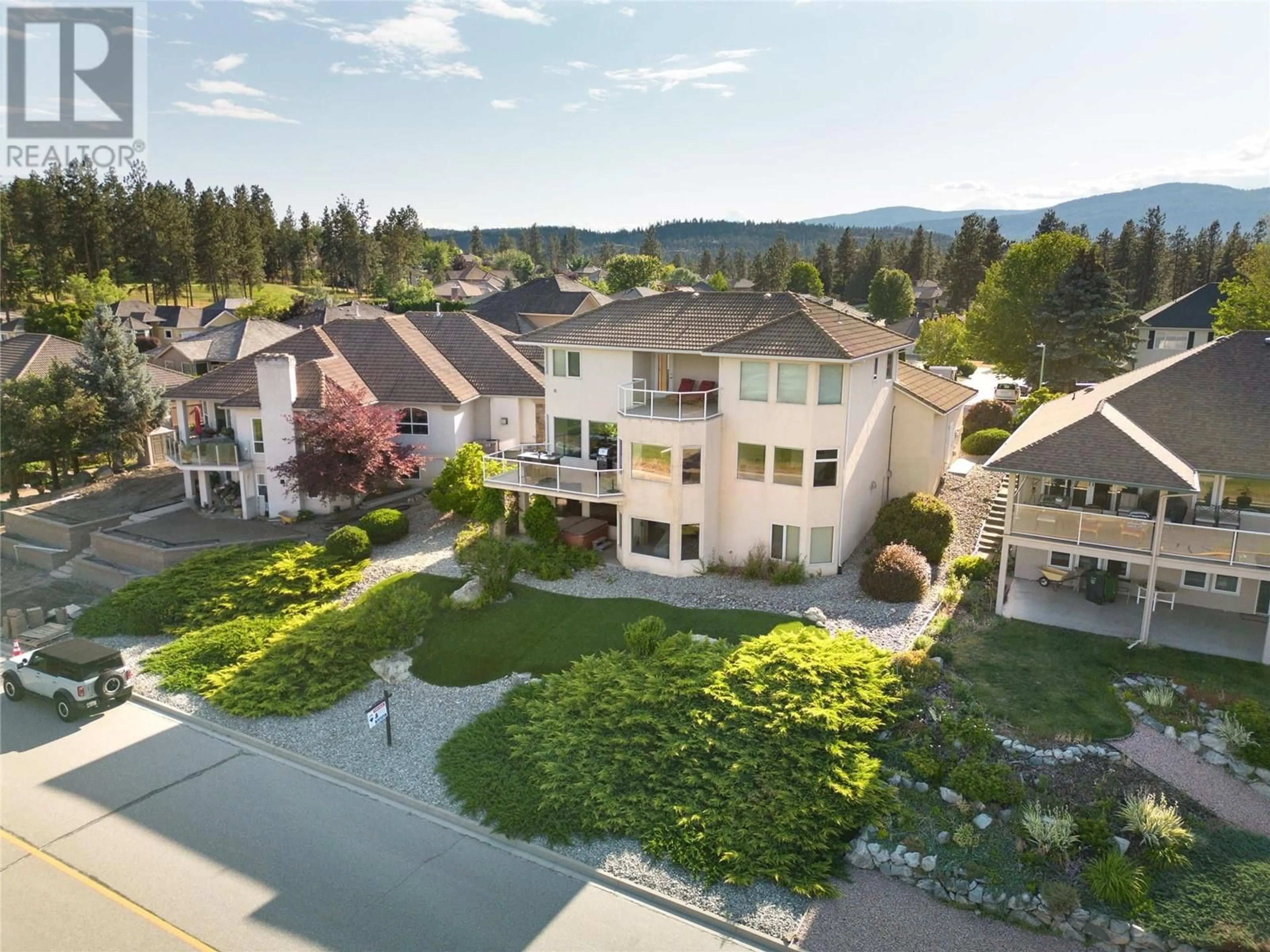 A pic from outside/outdoor area/front of a property/back of a property/a pic from drone, mountain view for 3076 Quail Crescent, Kelowna British Columbia V1V2A1