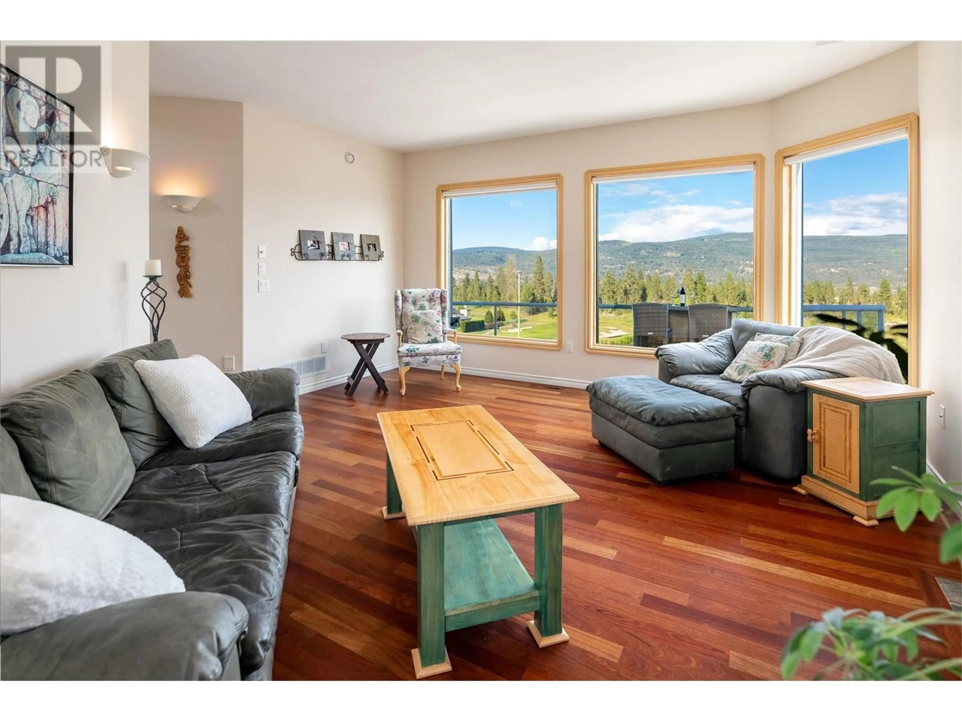 Living room with furniture, wood/laminate floor for 3076 Quail Crescent, Kelowna British Columbia V1V2A1