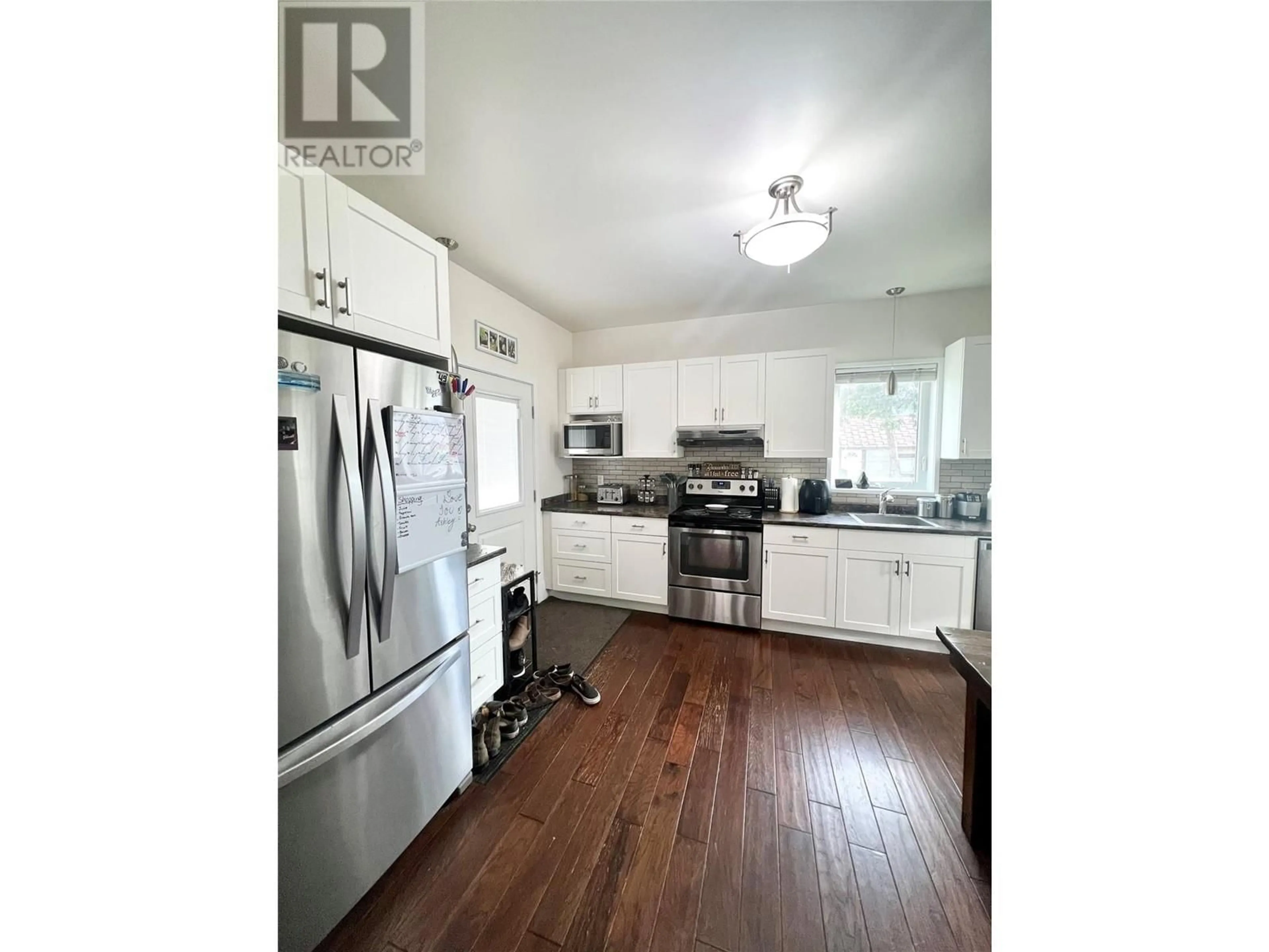 Open concept kitchen, wood/laminate floor for 1902 Nicola Avenue, Merritt British Columbia V1K1R6