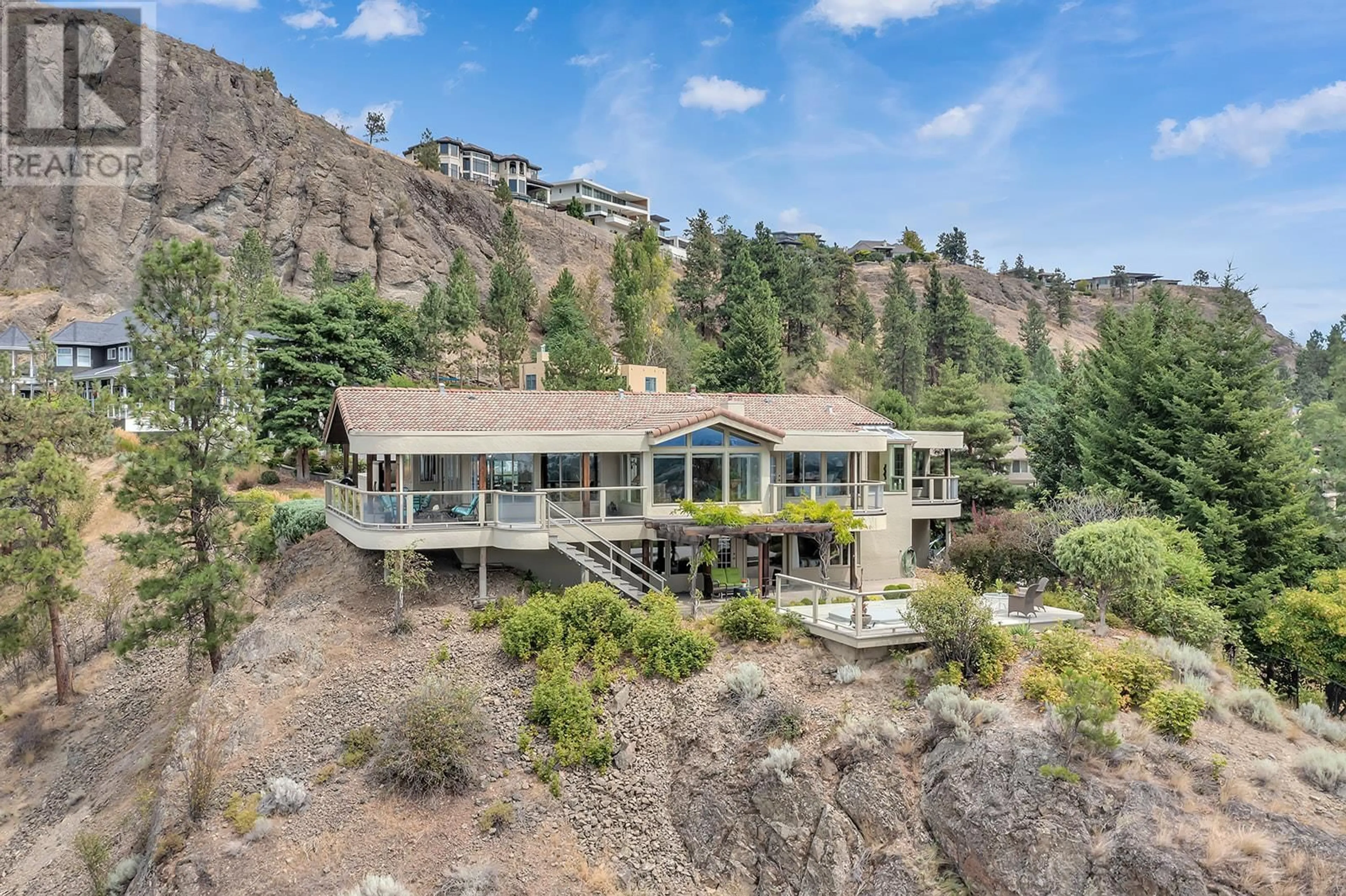 A pic from outside/outdoor area/front of a property/back of a property/a pic from drone, mountain view for 828 Mount Royal Drive, Kelowna British Columbia V1Y8G3