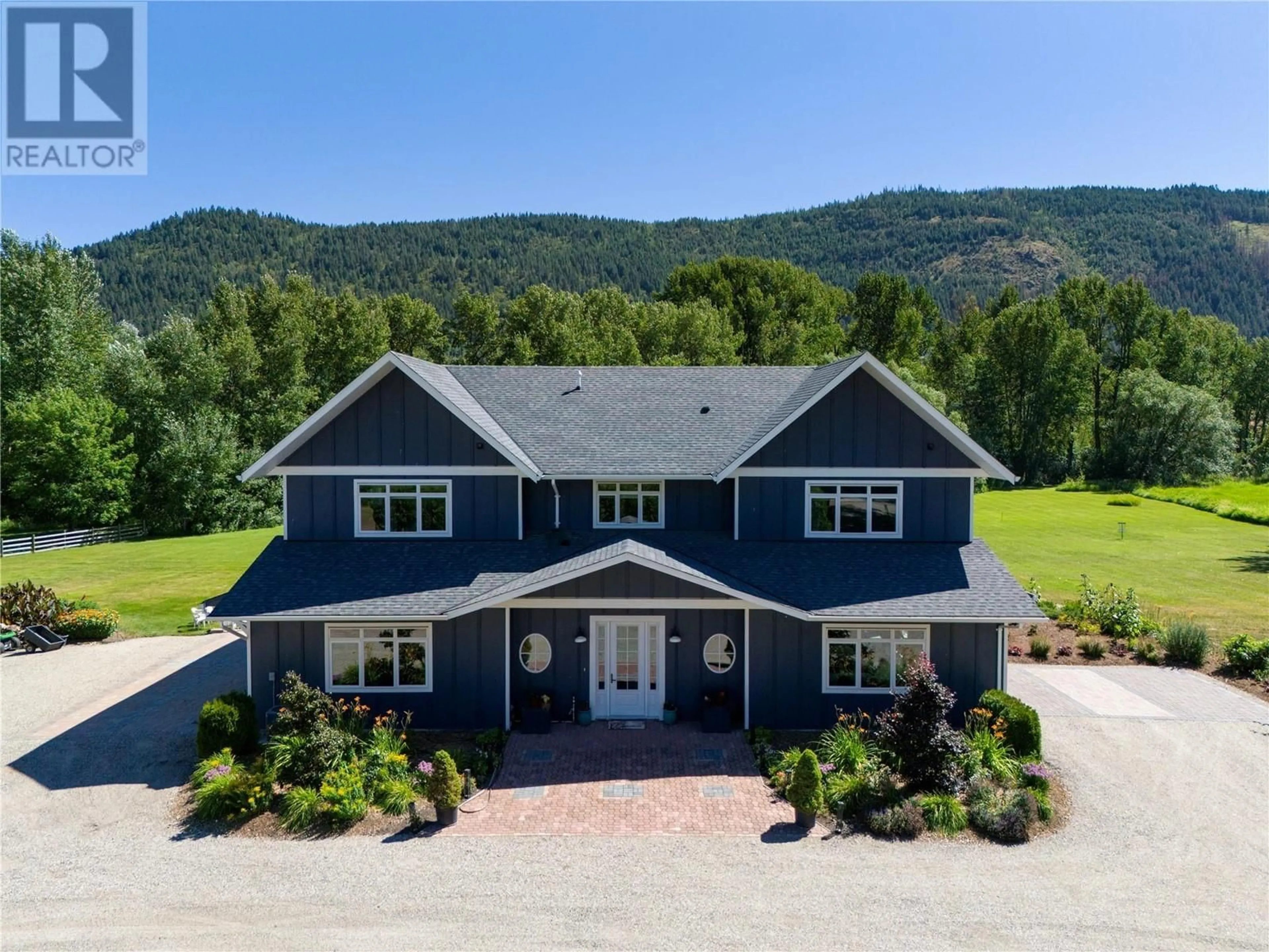 A pic from outside/outdoor area/front of a property/back of a property/a pic from drone, mountain view for 6984 Highway 6, Coldstream British Columbia V1B3H1