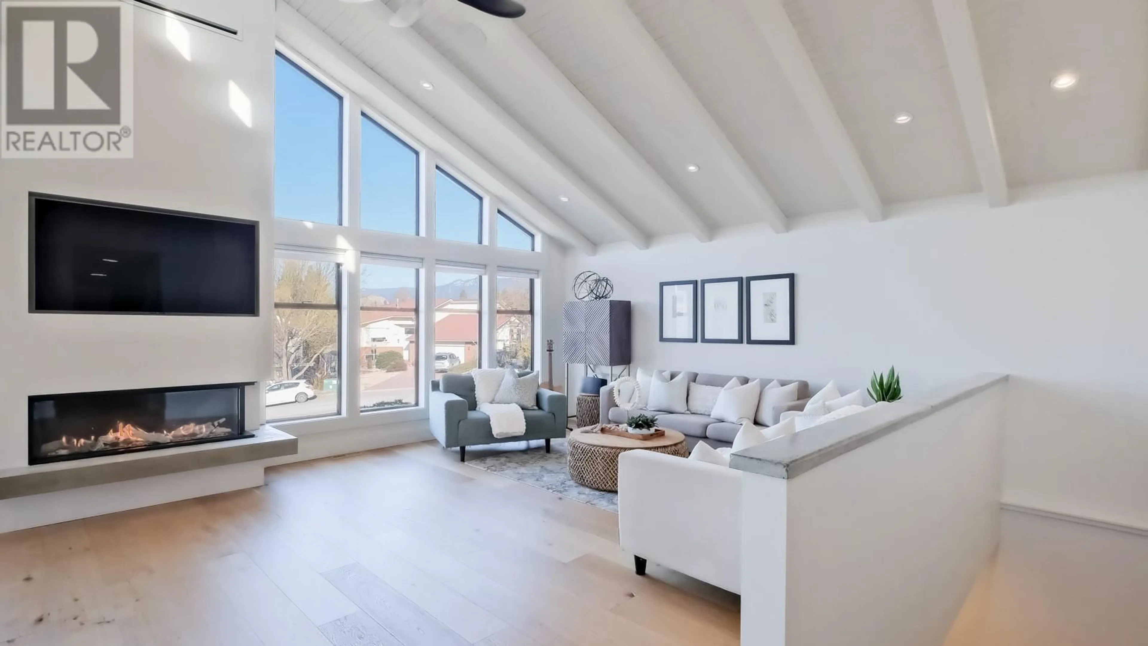 Living room with furniture, wood/laminate floor for 102 MILLAR Place, Penticton British Columbia V2A7Z9