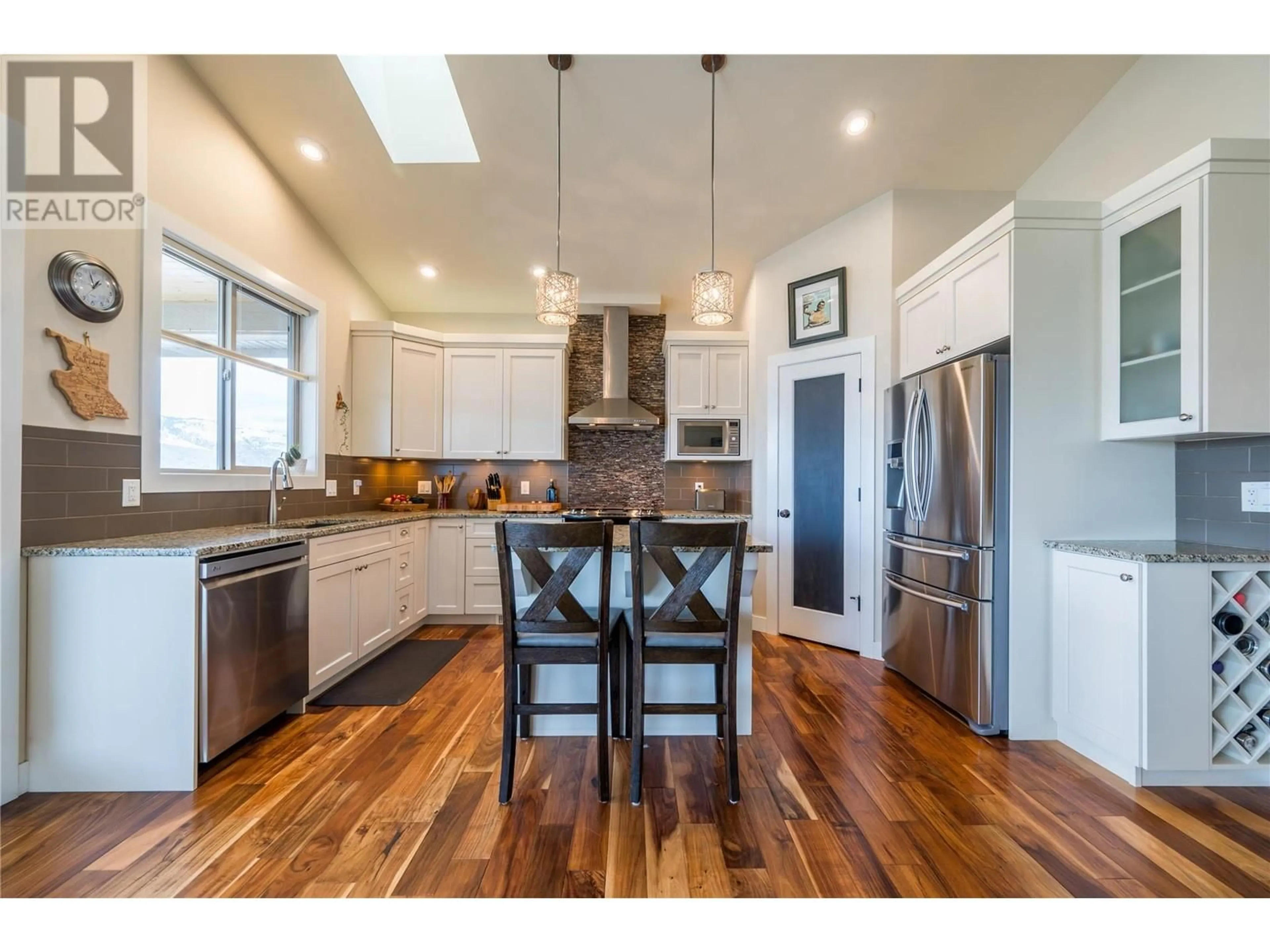 Open concept kitchen, wood/laminate floor for 2024 Galore Crescent, Kamloops British Columbia V2E0A7