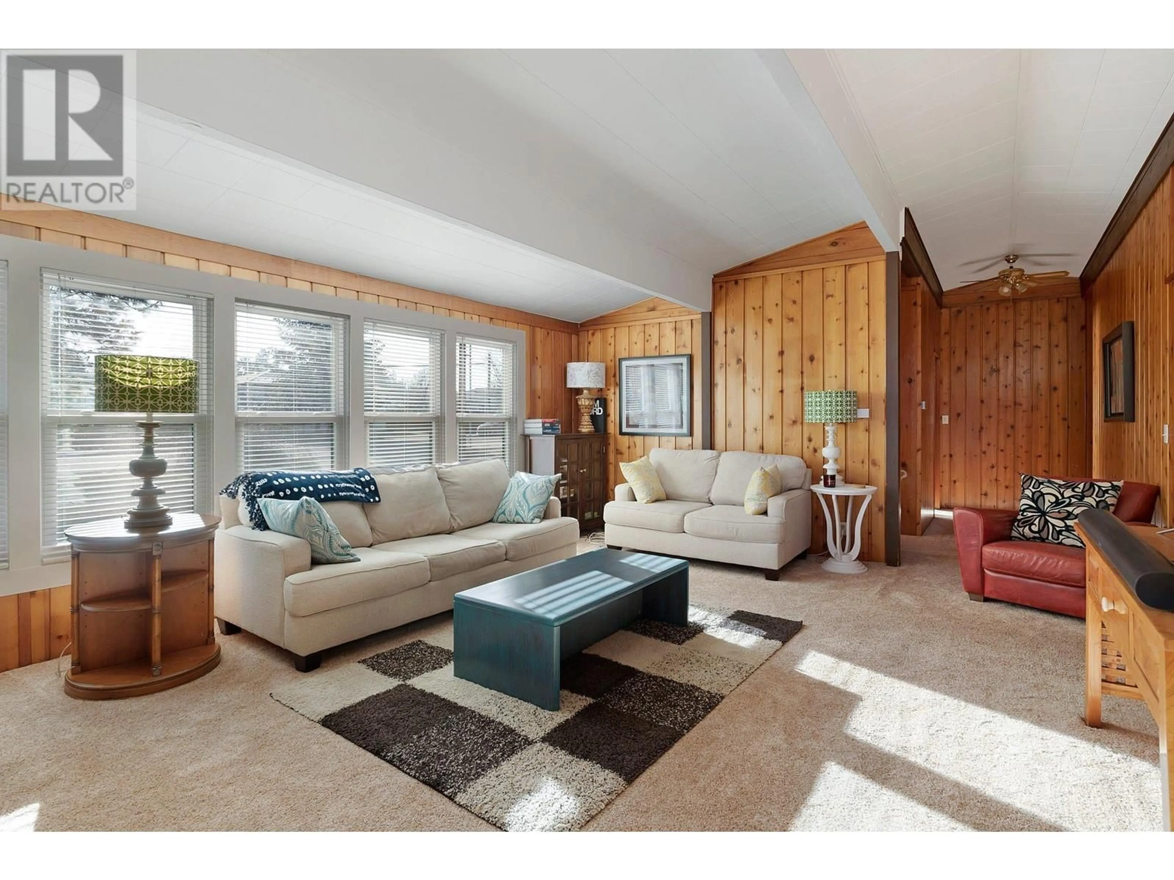 Living room with furniture, wood/laminate floor for 810 Belgo Road, Kelowna British Columbia V1X3A7