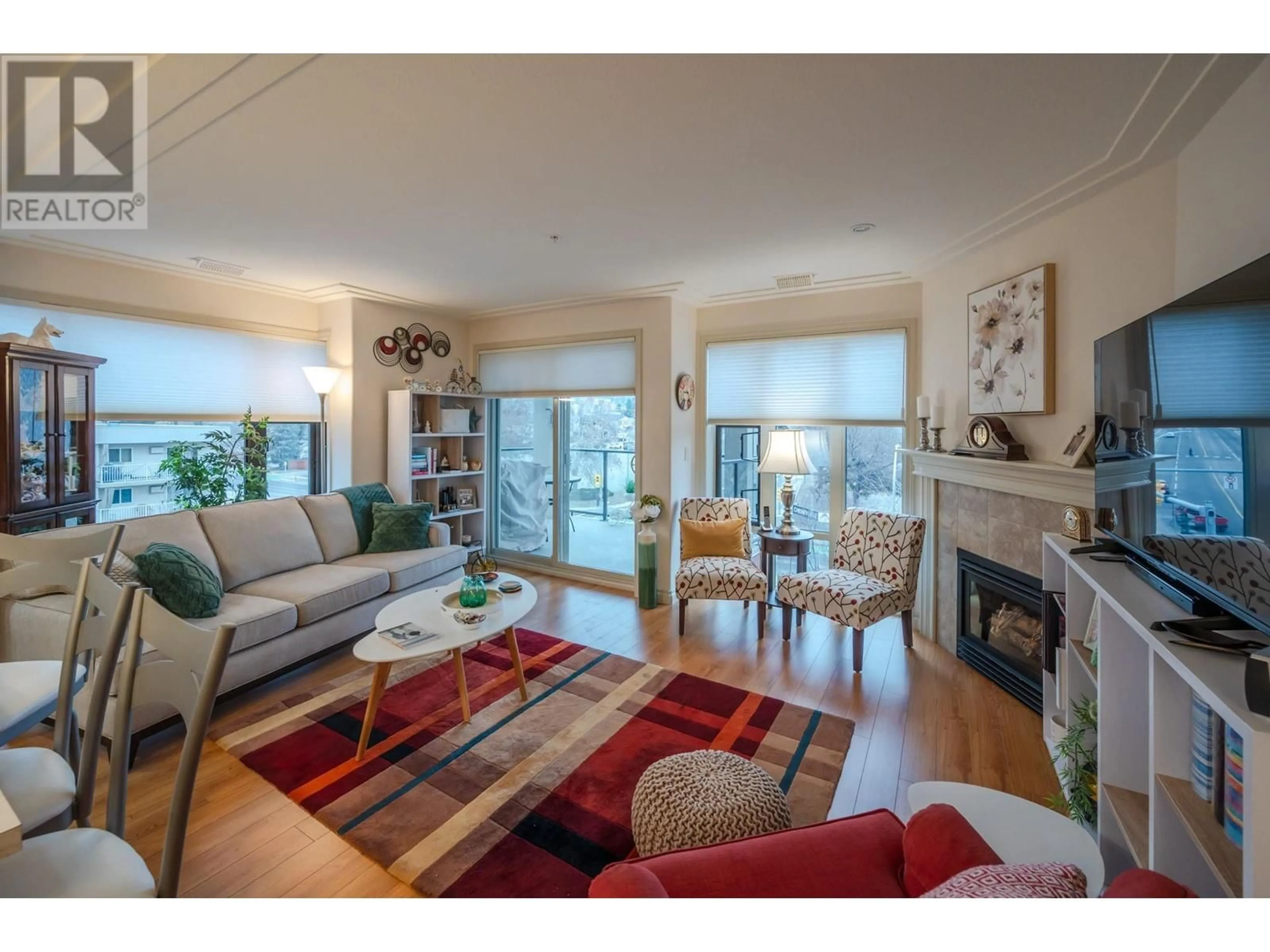Living room with furniture, wood/laminate floor for 406 - 2113 ATKINSON STREET, Penticton British Columbia V2A8R5
