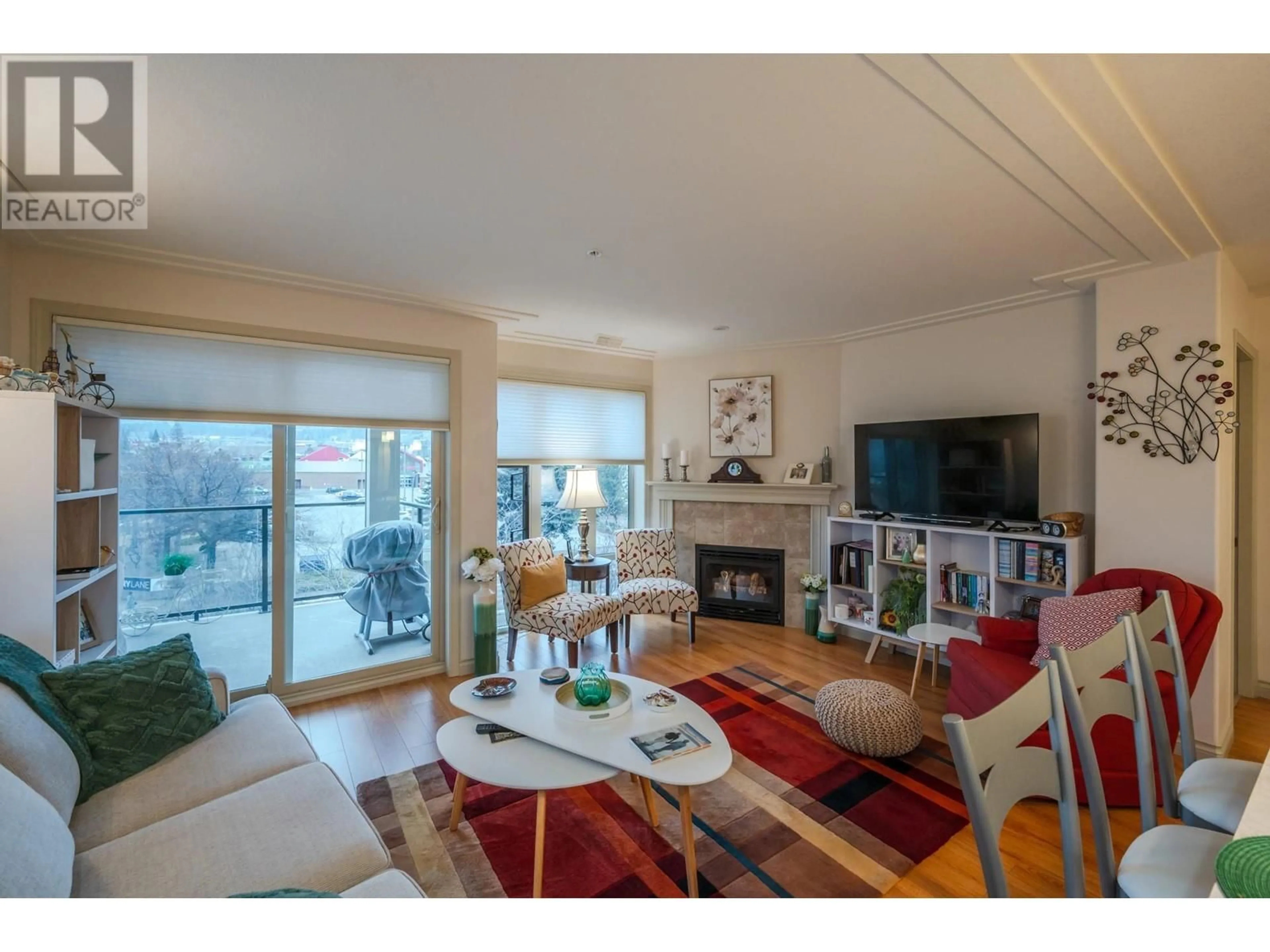 Living room with furniture, wood/laminate floor for 406 - 2113 ATKINSON STREET, Penticton British Columbia V2A8R5