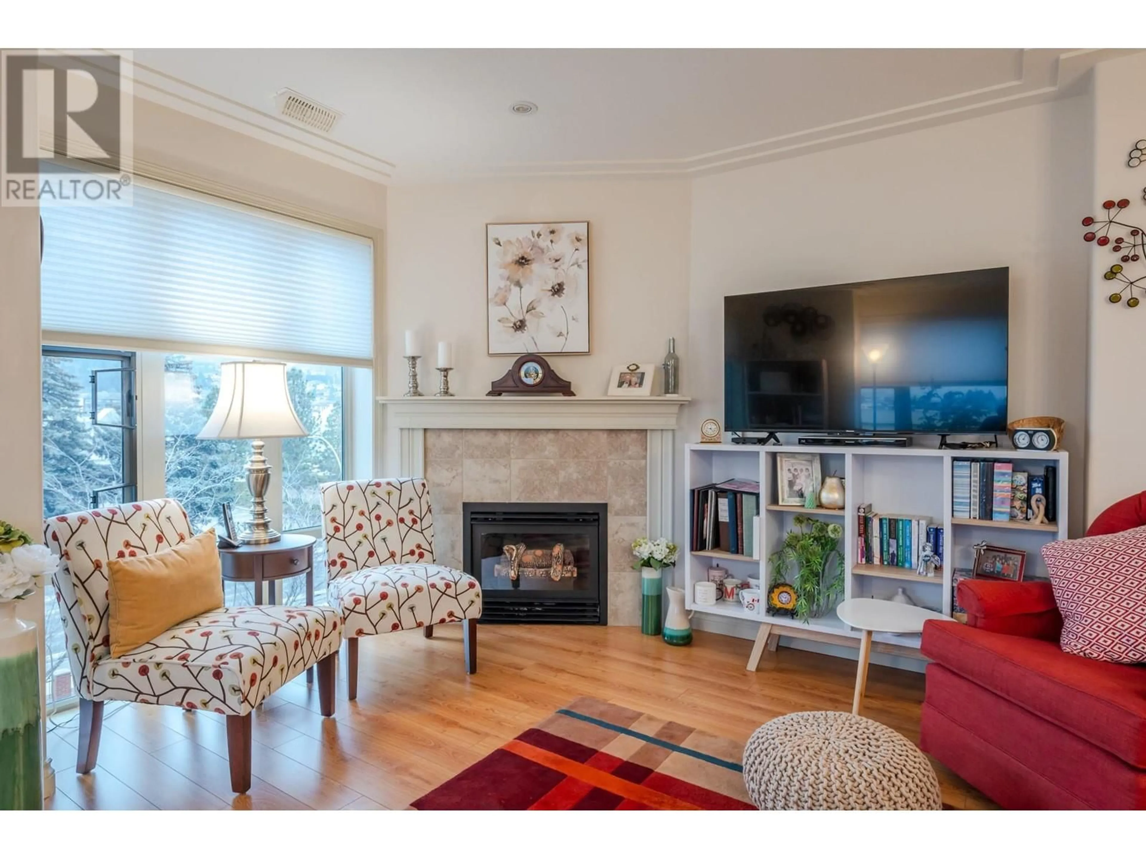 Living room with furniture, wood/laminate floor for 2113 Atkinson Street Unit# 406, Penticton British Columbia V2A8R5