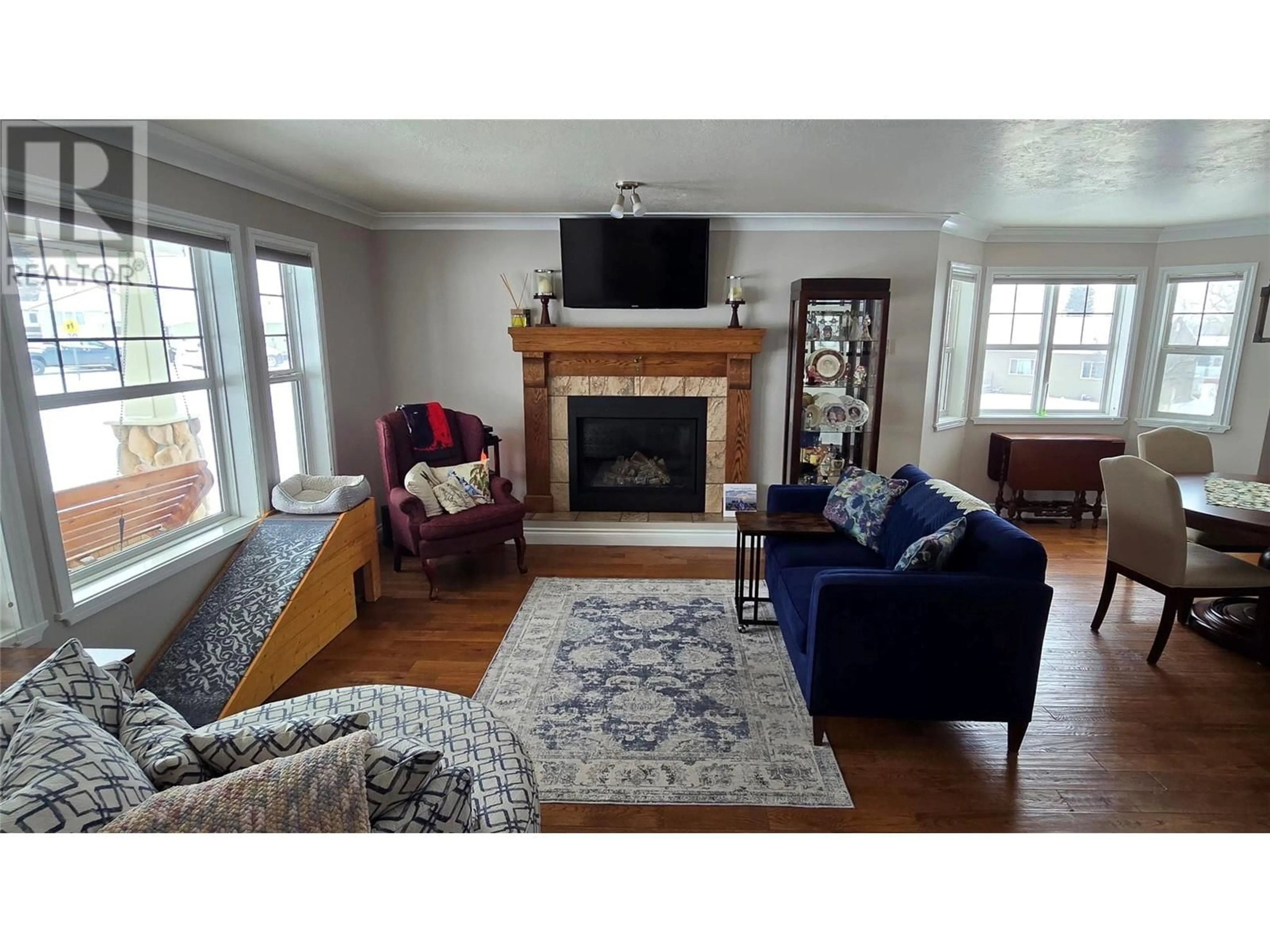 Living room with furniture, wood/laminate floor for 1820 110 Avenue, Dawson Creek British Columbia V1G0A3