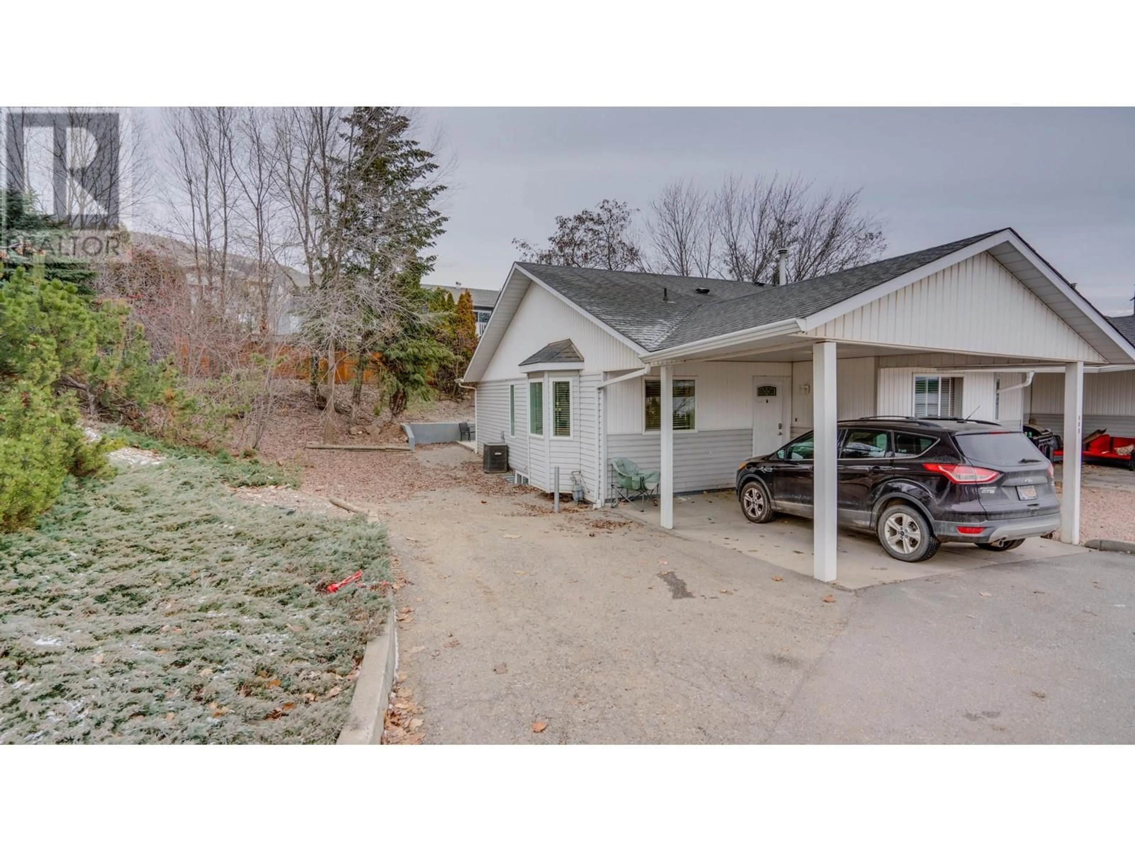 A pic from outside/outdoor area/front of a property/back of a property/a pic from drone, street for 1041 Middleton Way Unit# 103, Vernon British Columbia V1B2N3