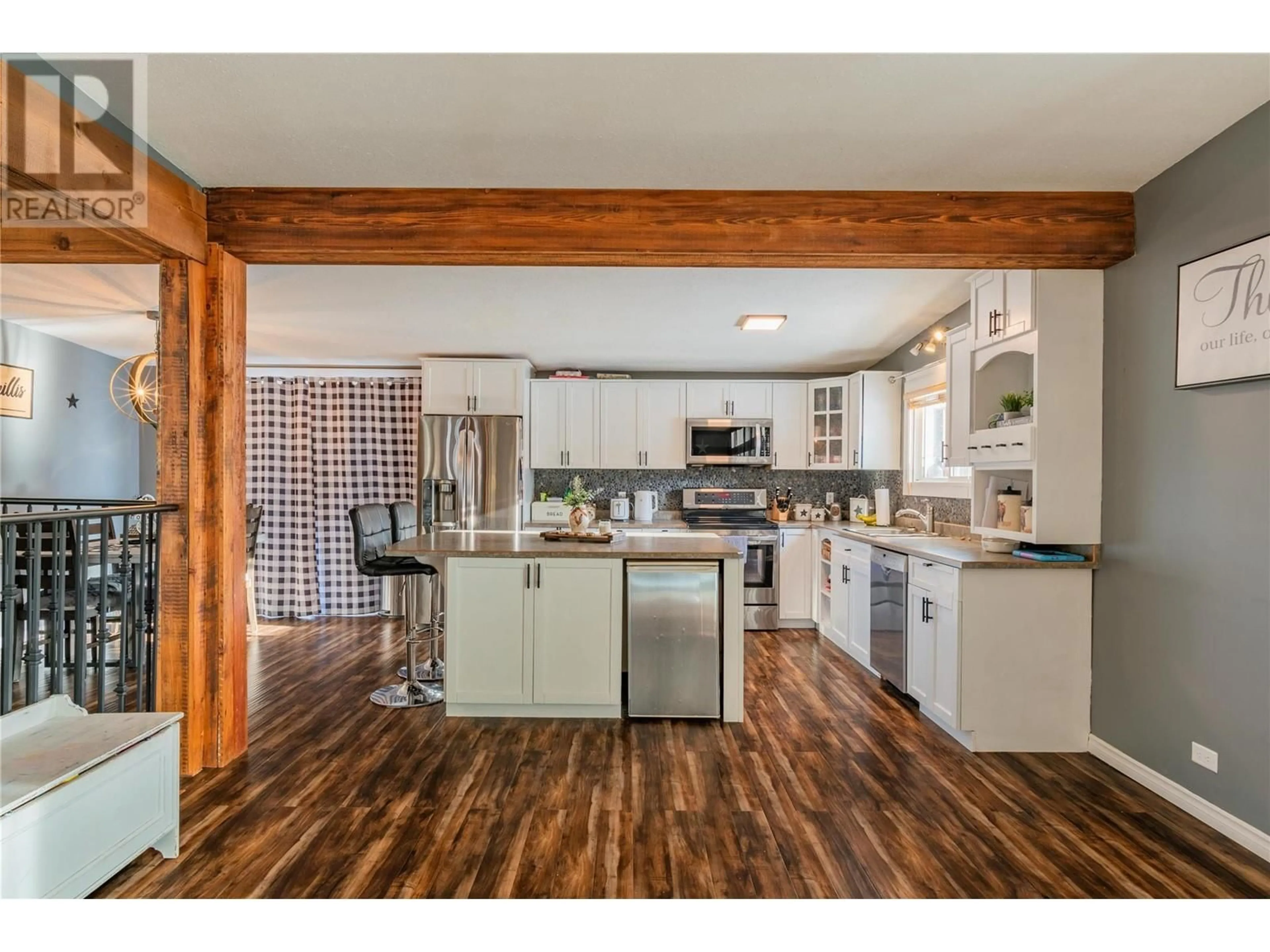 Open concept kitchen, wood/laminate floor for 1080 Highway 3B Highway, Beaver Falls British Columbia V0G1P0