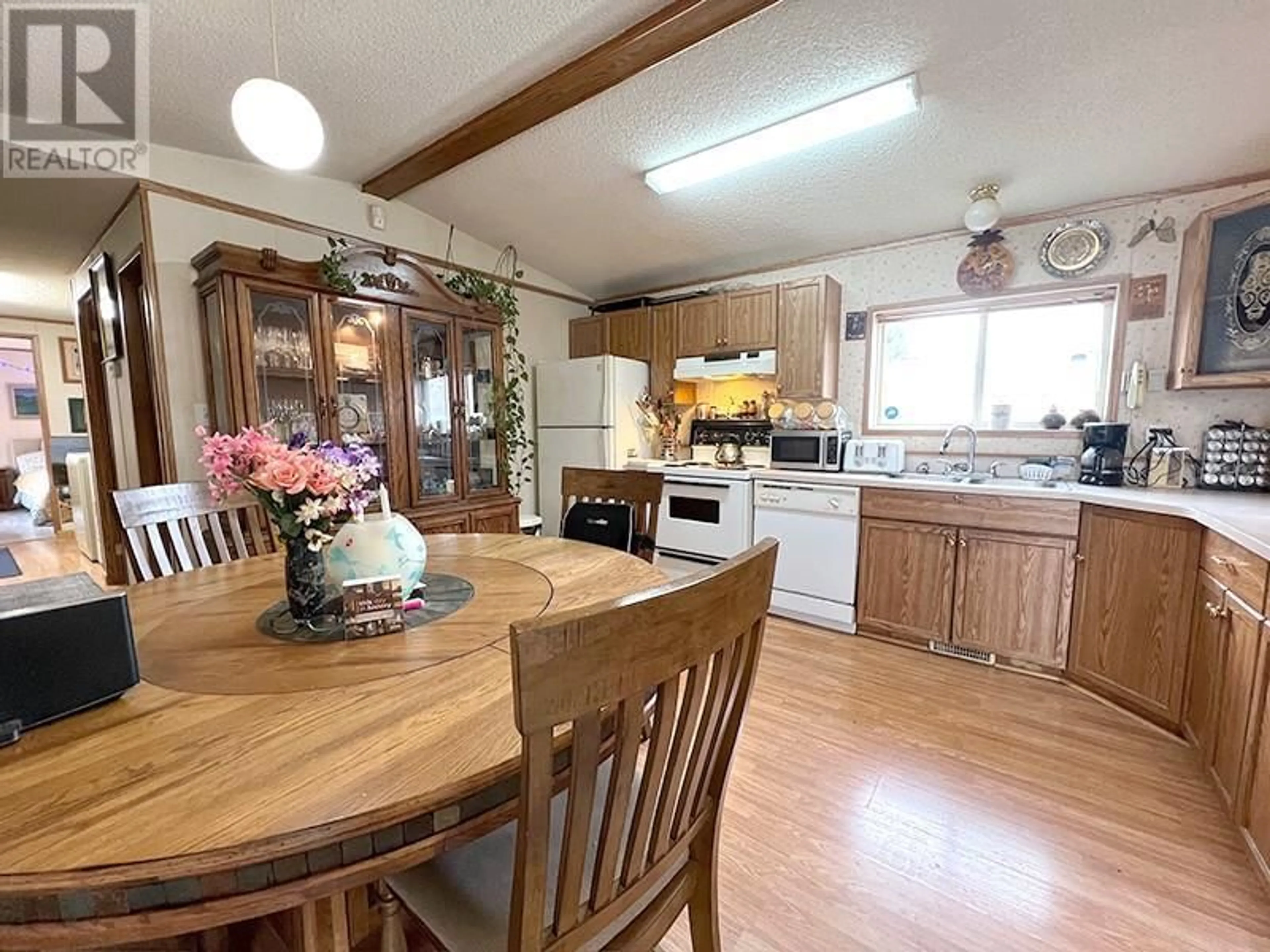 Open concept kitchen, wood/laminate floor for 14 PLUTO Drive, Kamloops British Columbia V2H1T7