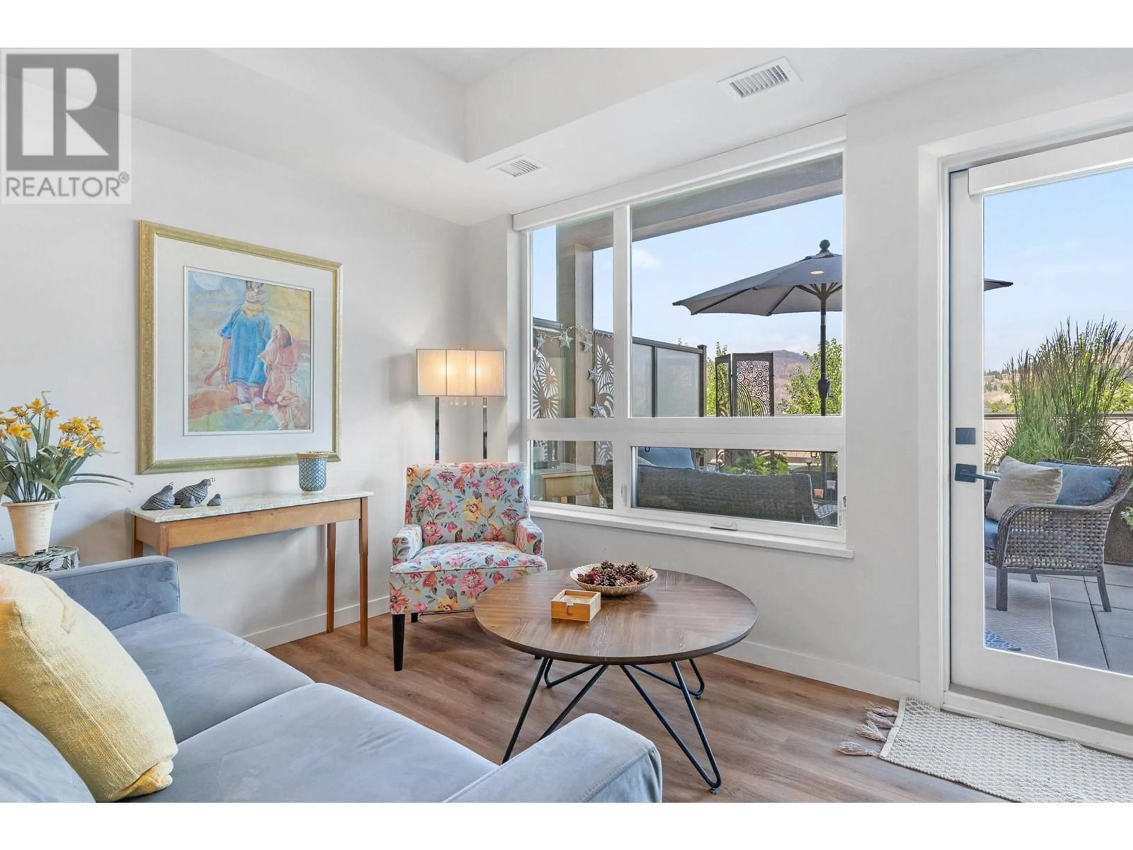 Living room with furniture, wood/laminate floor for 204 - 1215 ST. PAUL STREET, Kelowna British Columbia V1Y2C7