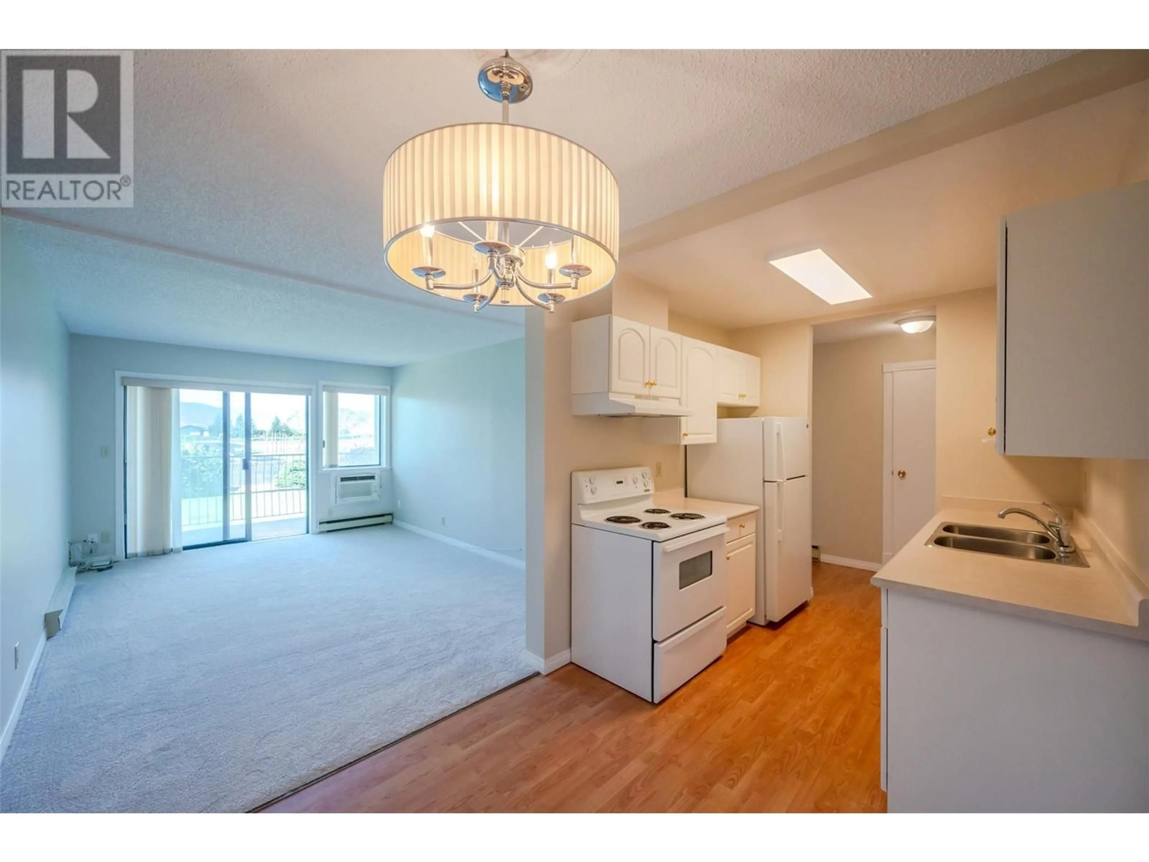 Open concept kitchen, wood/laminate floor for 8909 92nd Avenue Unit# 101, Osoyoos British Columbia V0H1V2