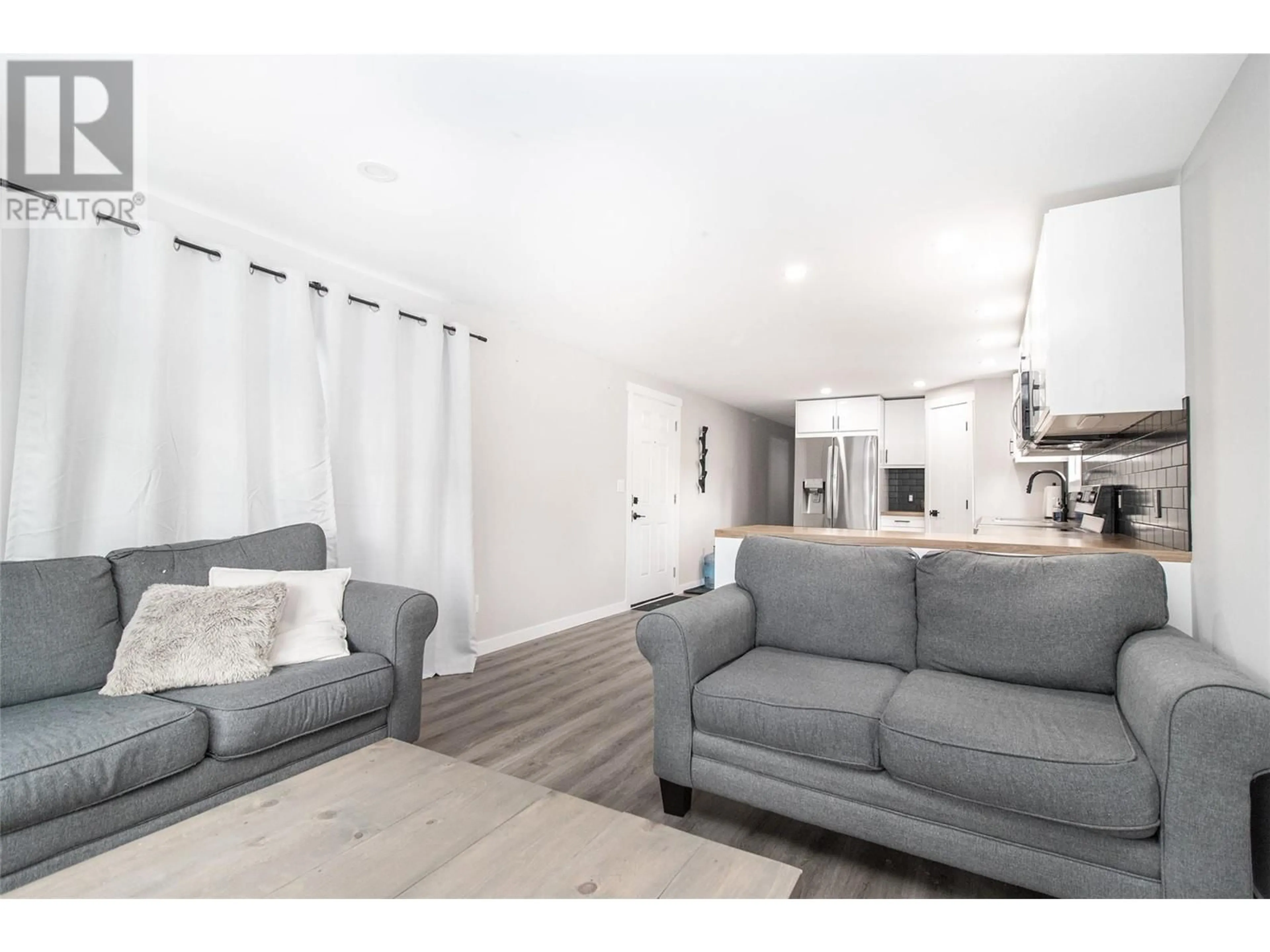 Living room with furniture, wood/laminate floor for 41 - 2065 BOUCHERIE ROAD, West Kelowna British Columbia V4T2A8